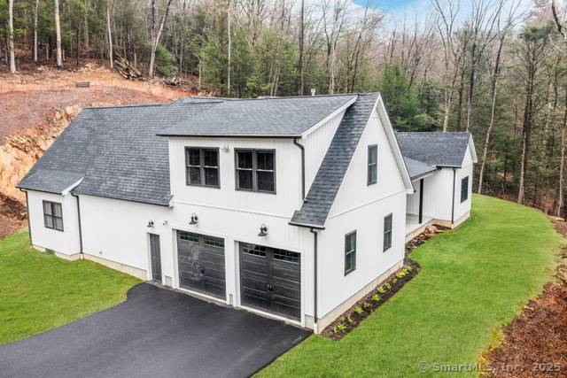MOTIVATED SELLERS Nestled in Harwinton, Connecticut, this MODERN FARMHOUSE RANCH effortlessly combines privacy and craftsmanship.