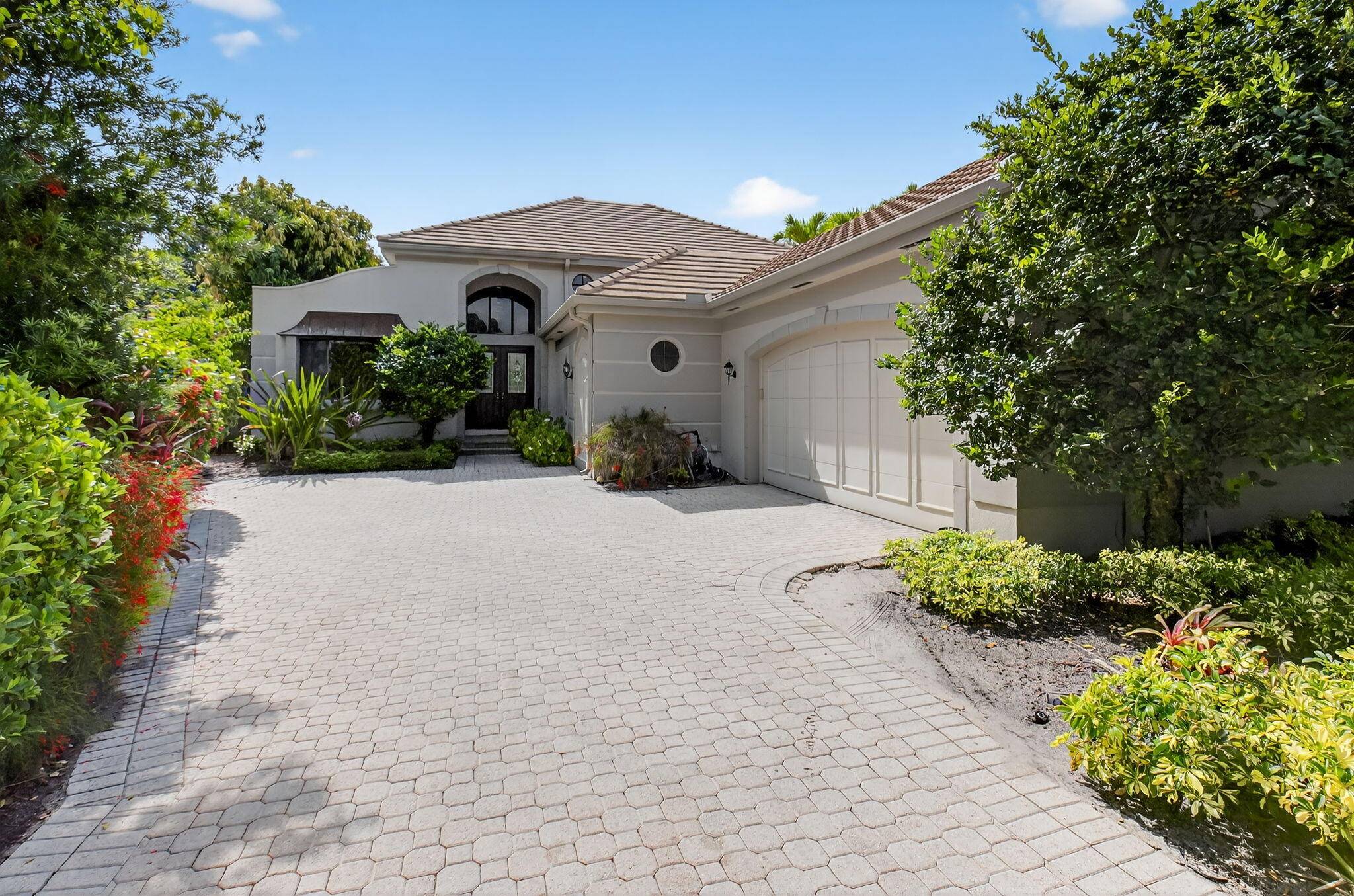 Welcome to this exquisite one level estate home located in the prestigious village of Vintage Place in Broken Sound Country Club.