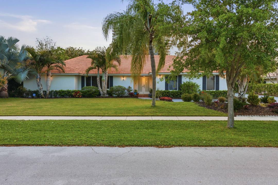 Welcome to an exceptional residence tucked within one of East West Palm Beach's most exclusive gated communities, ideally positioned east of I 95 along a mature, tree lined street.