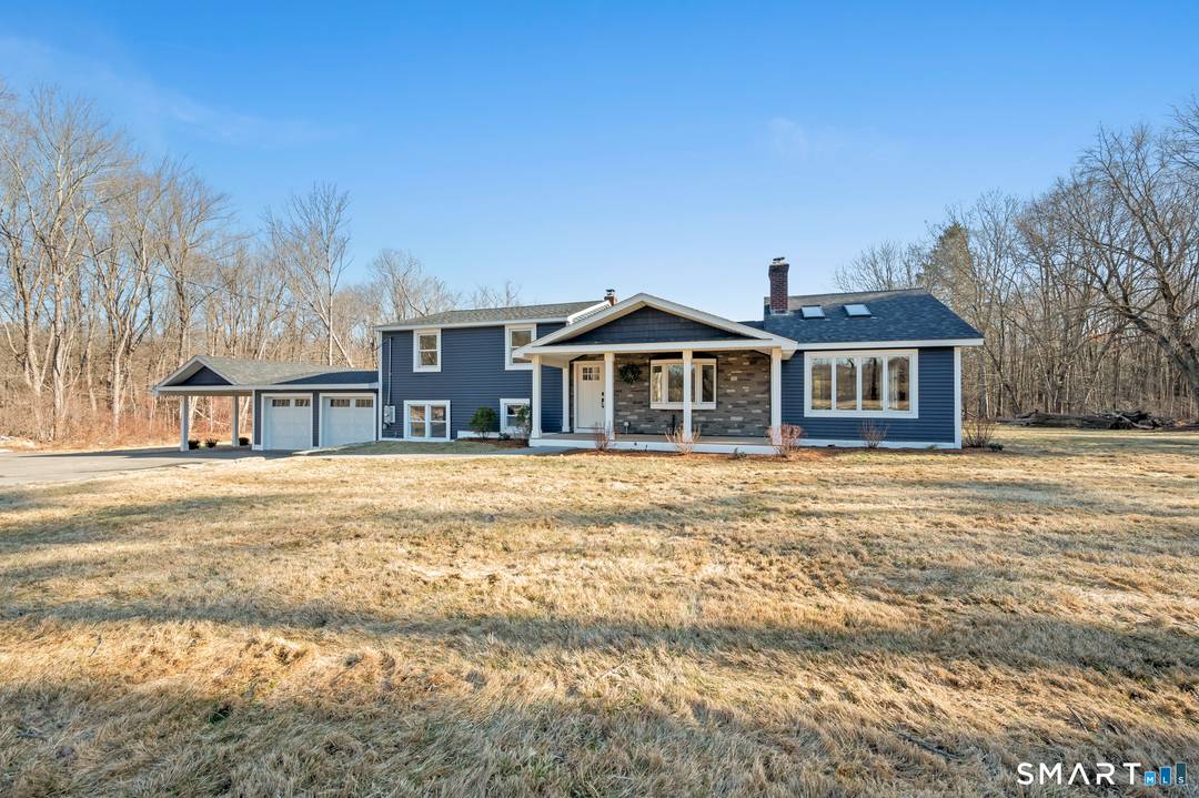 Beautiful split level home set on a level lot with an inground pool and circular driveway.