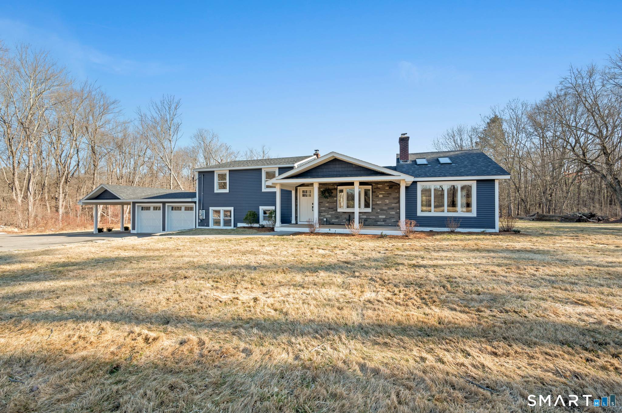 Beautiful split level home set on a level lot with an inground pool and circular driveway.