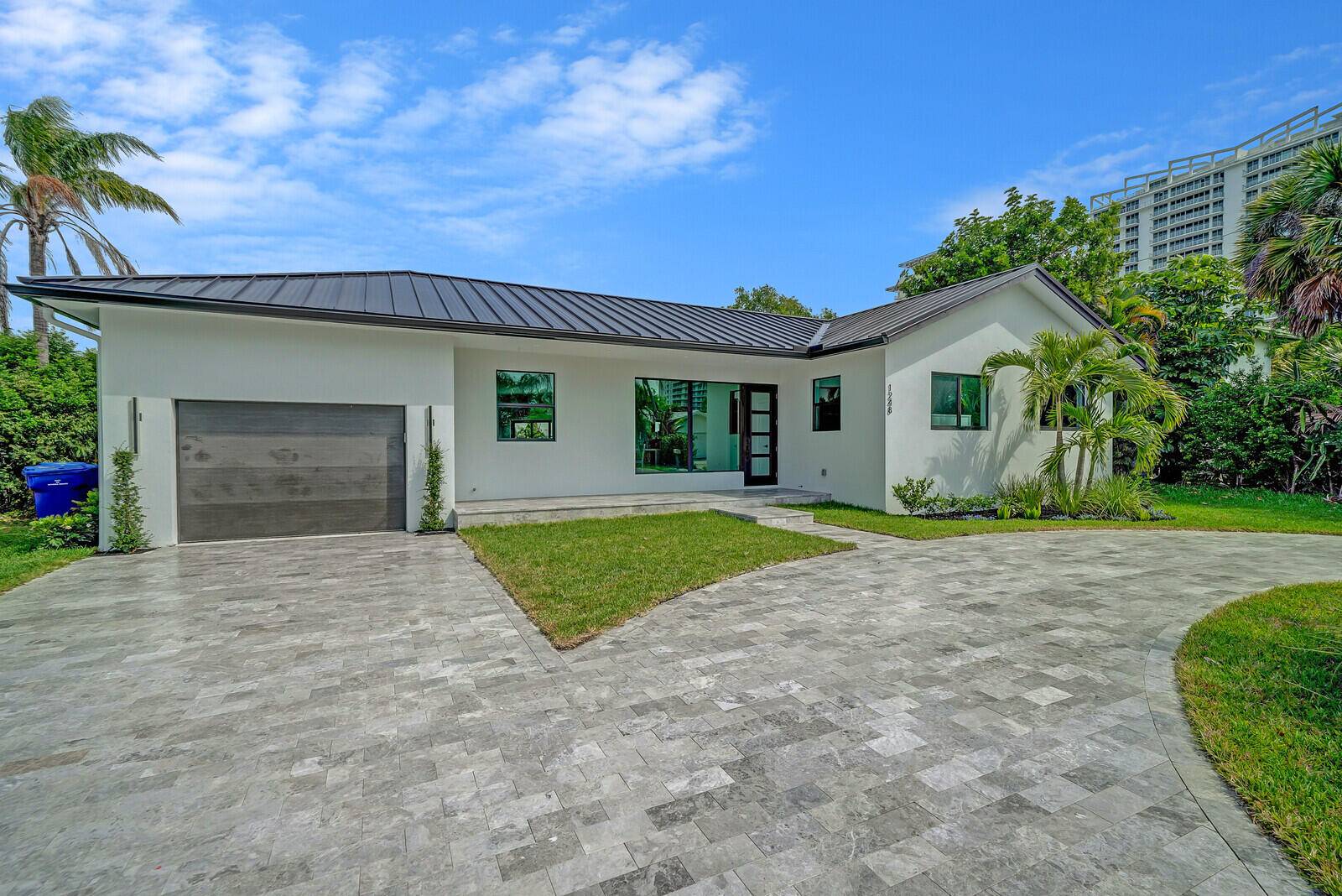 Live the luxe coastal lifestyle just one block from the beach in this beautifully renovated Singer Island sanctuary !