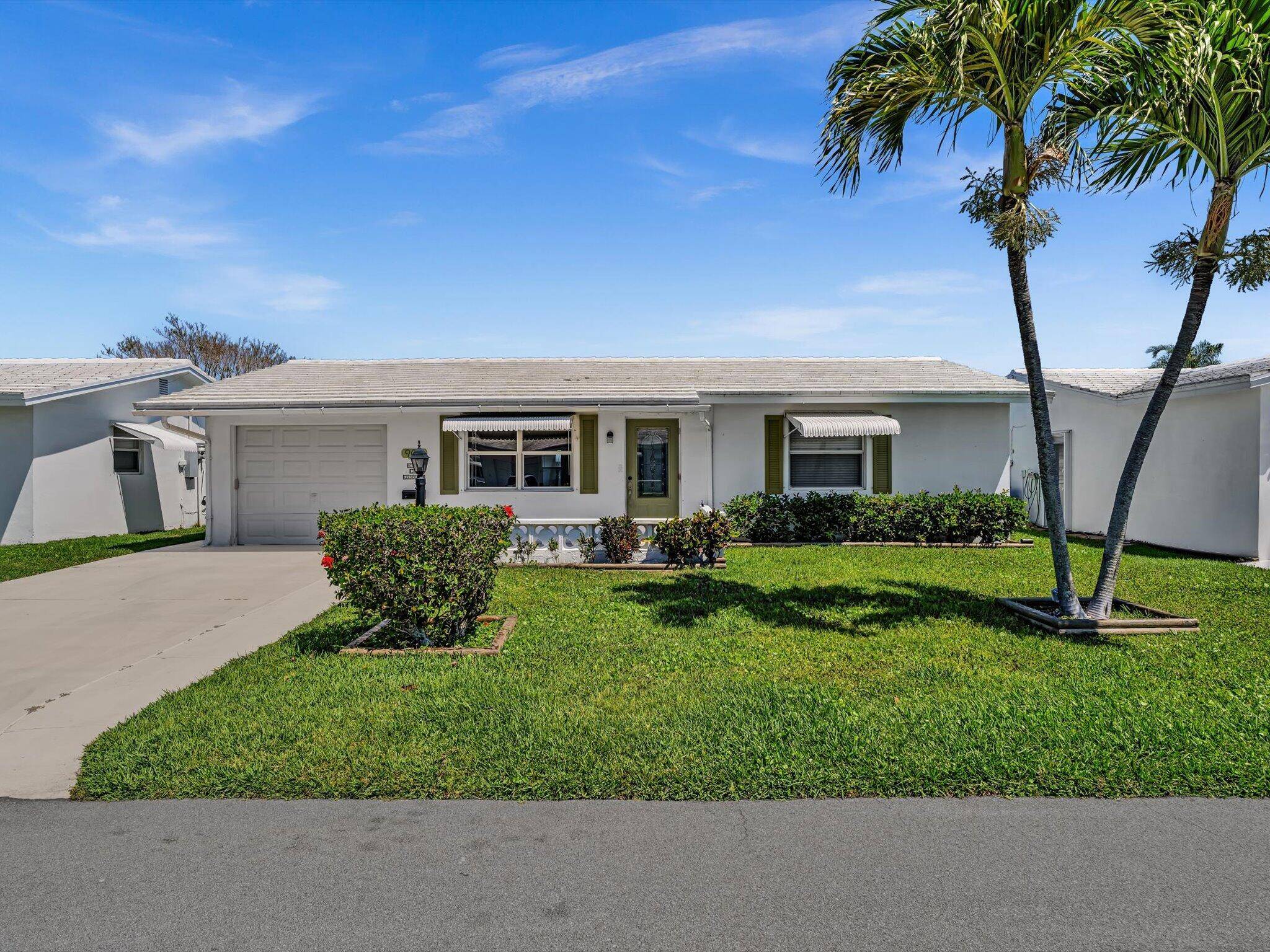 Bright and airy floor plan with a rare, open, and spacious kitchen with white cabinets, featuring a center island an uncommon upgrade in Palm Beach Leisureville !