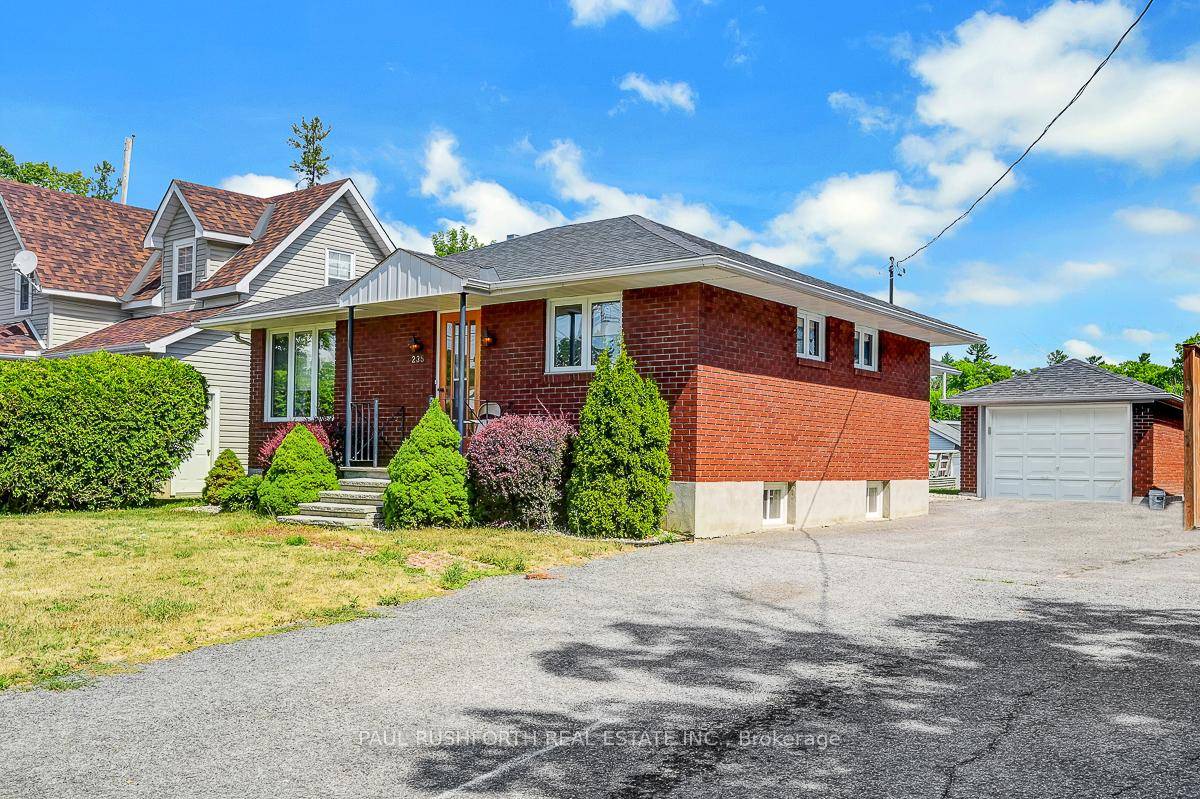 DETACHED BUNGALOW with DETACHED GARAGE WORKSHOP on MASSIVE LOT in booming DOWNTOWN ARNPRIOR.