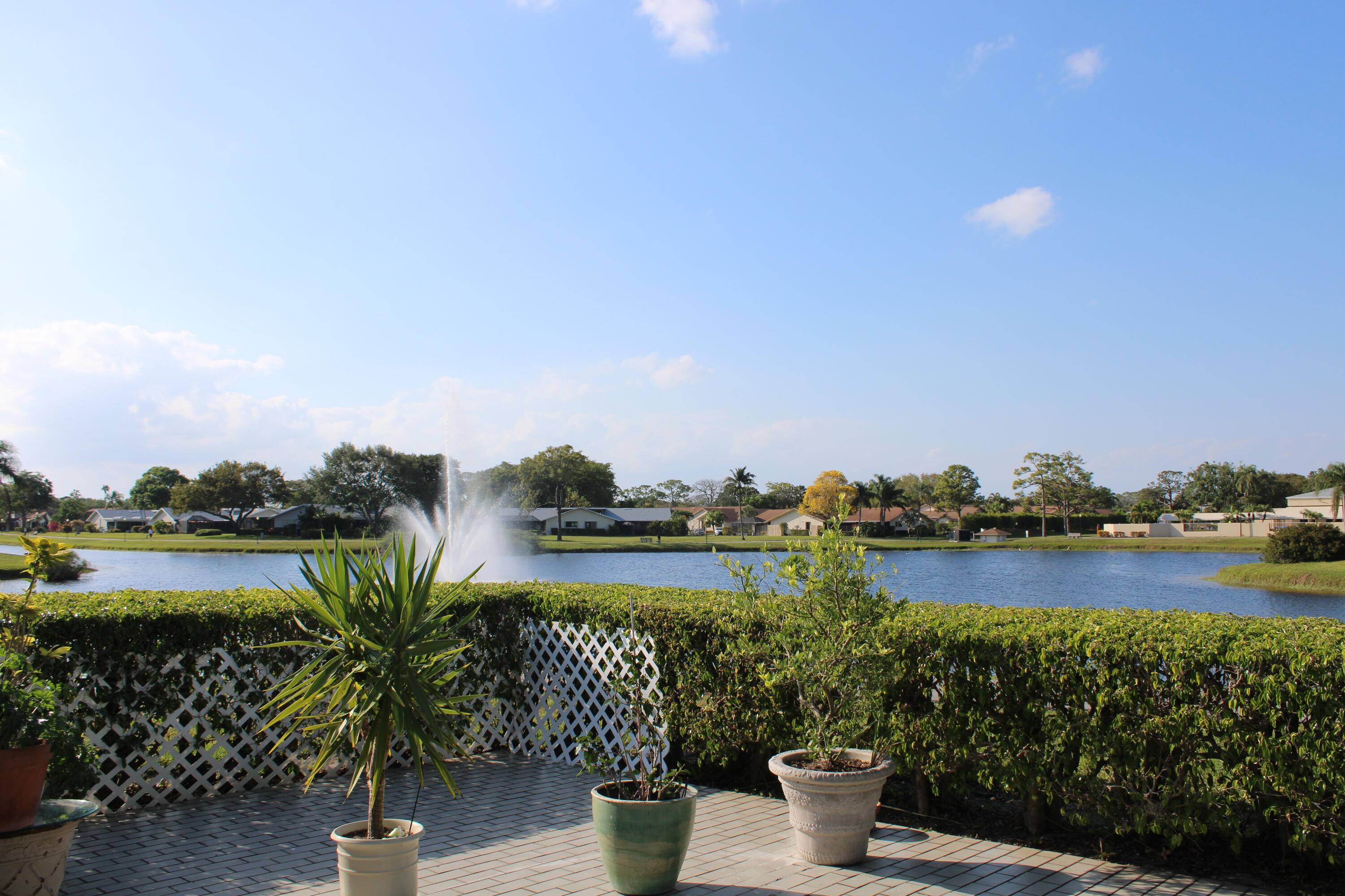 STUNNING LAKE VIEWS, CORNER WATERFRONT HOME WITH CROSSBREEZES, SERENE LAKEFRONT, BEAUTIFUL LANDSCAPING AND PARK LIKE SETTING, WALKING PATHS.
