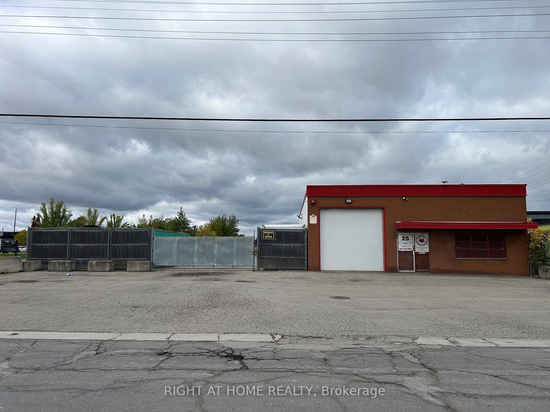 Freestanding industrial building with fenced in outside storage.