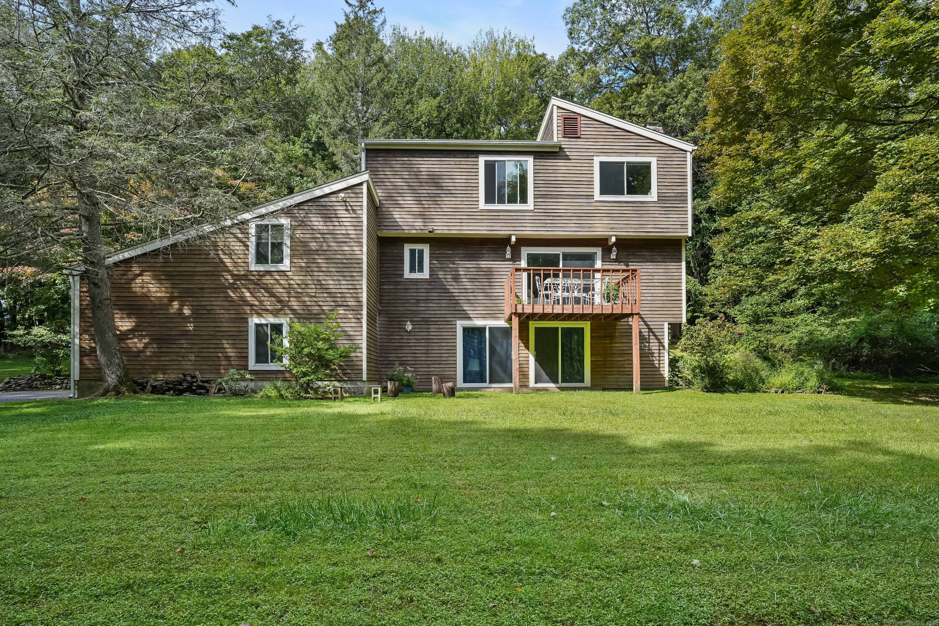 Tucked away on a peaceful cut de sac and boarderd by the serene woodlands of Putnam State Park, this fully renovated contemporary offers a blend of modern luxury and natural ...