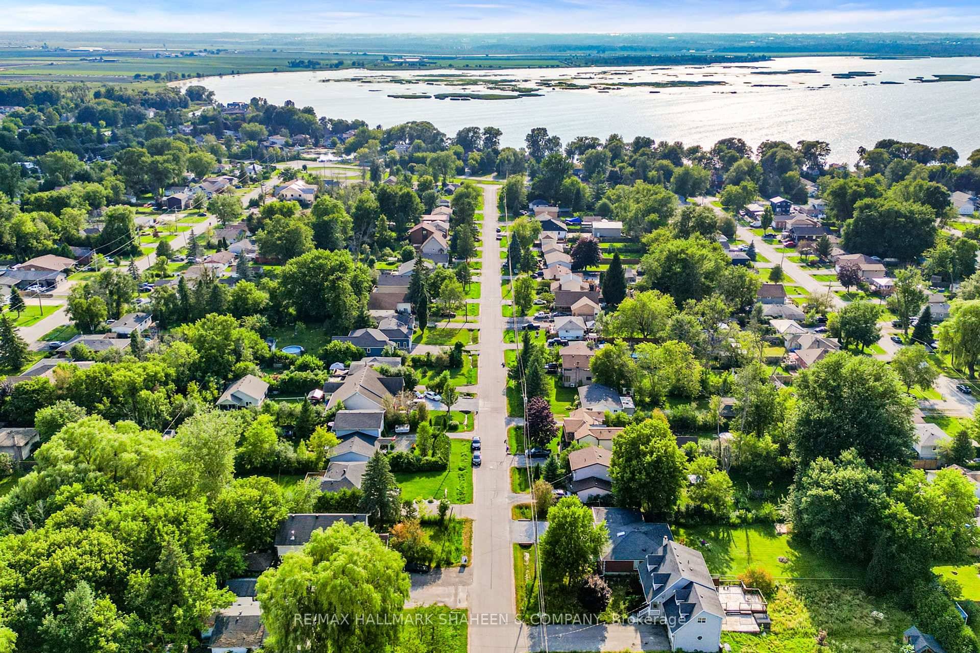 Welcome to this warm and inviting home, ideally located just steps from beautiful Lake Simcoe where the cozy charm of a cottage meets the practicality of a year round residence.
