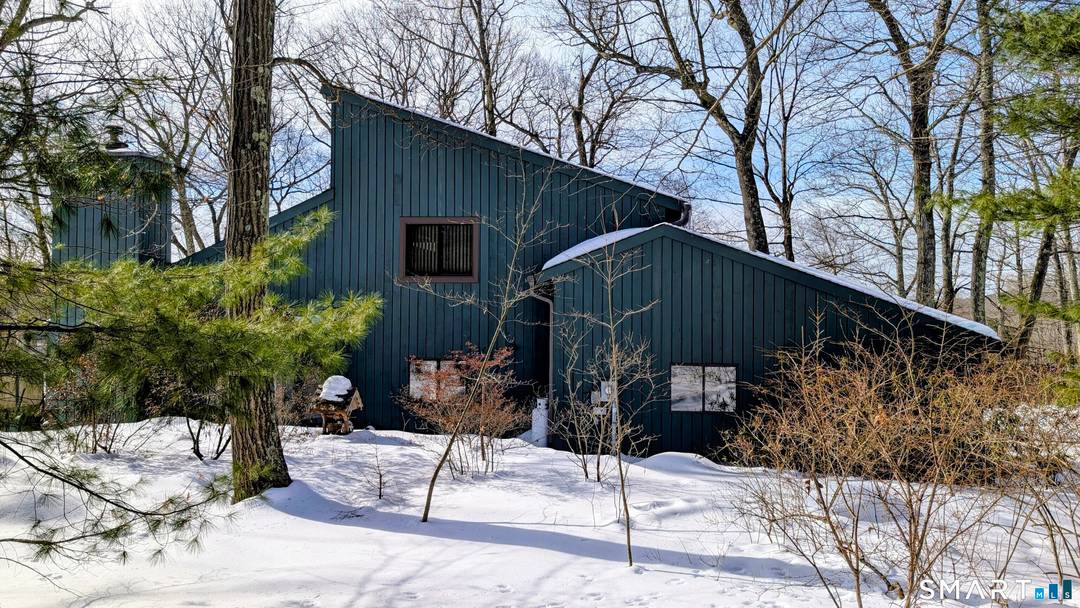 Tucked away on a quiet cul de sac street, this contemporary three bedroom, two and a half bath home offers seasonal water views and exceptional privacy surrounded by natural rock ...