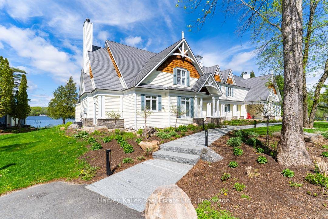 A rare and highly desirable offering of a Lake Joe Club waterside end unit Villa serving up stunning views of Lake Joseph in the prestigious Port Sandfield locale.