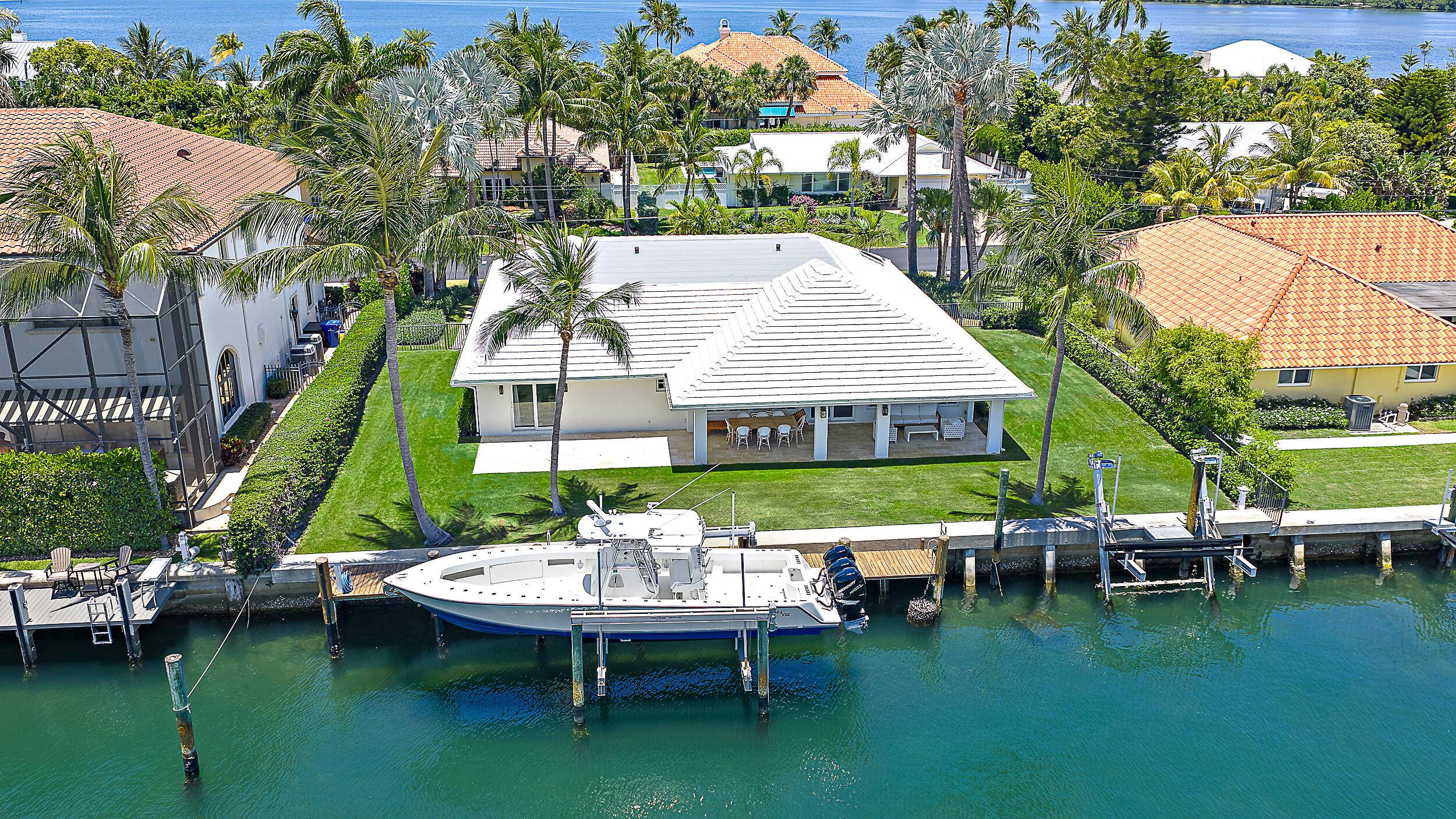 Just minutes from the Palm Beach Inlet this Palm Beach Isles home offers 100' of deepwater frontage, a 65' dock with two boat lifts 24, 000lbs 10, 000lbs.