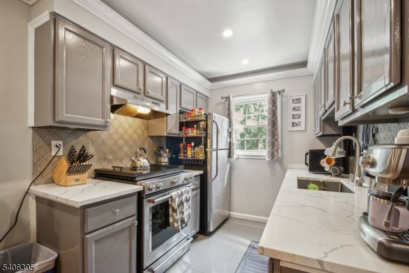 Experience refined living in this exquisitely renovated, sun drenched one bedroom first floor condo, where elegance and modern design converge.