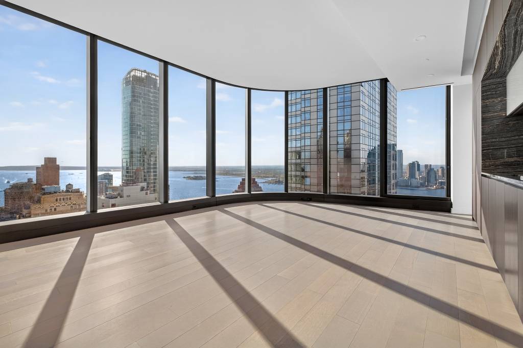 Welcome to Residence 61D at The Greenwich by Rafael Vinoly, a unique high floor studio with 10 foot ceilings and southern and western exposures, showcasing panoramic views of lower Manhattan, ...