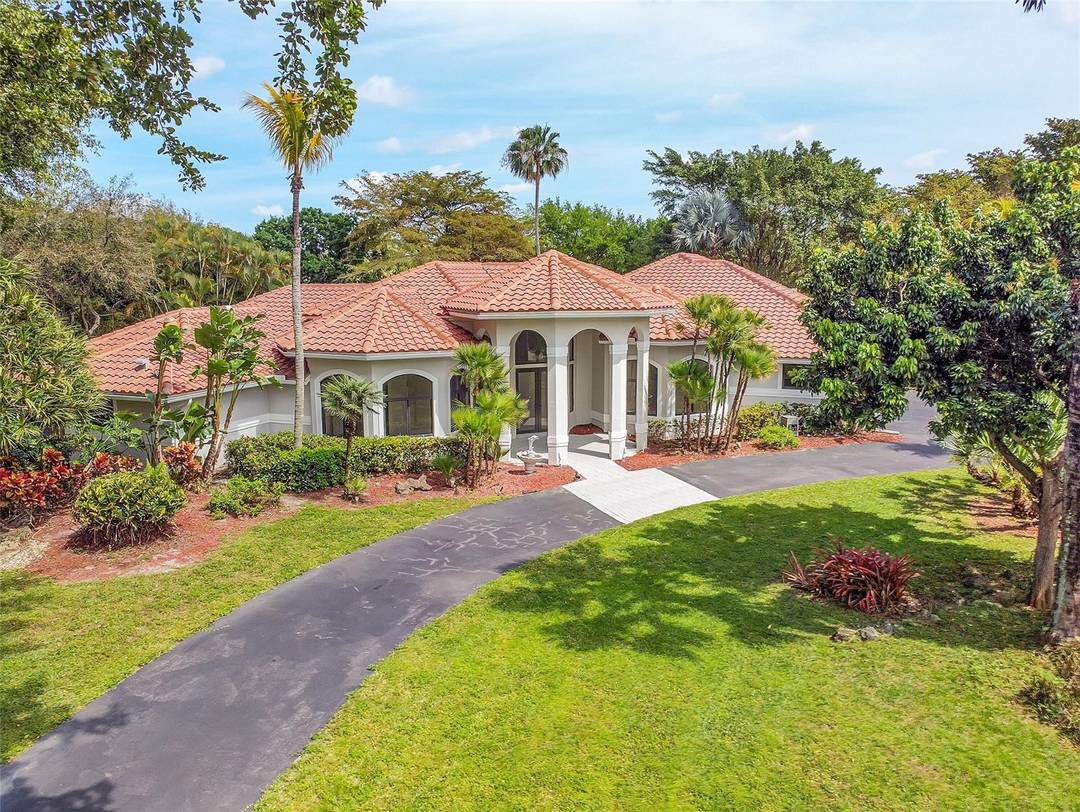 Enjoy refined living in this exquisite 5 bed, 4 bath estate on an expansive 45k sqft lot in the exclusive gated community of Whispering Woods.