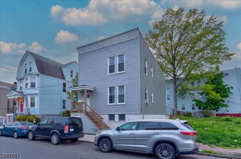 Back on Market. Introducing this stunning 2 family property that boasts modern design and exceptional features.