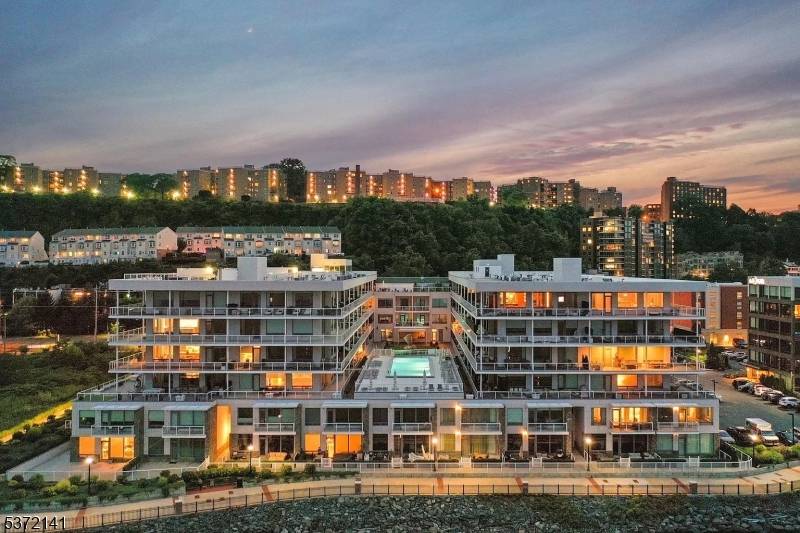 Luxury Waterfront Living at The Glass House 1BR Den w Private Balcony Manhattan Views Step into luxury at Edgewater's premier waterfront residence.