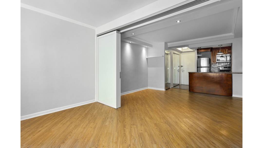 A generously proportioned residence intelligently converted into a true one bedroom with an additional den office in one of Sutton Place's most well managed coops.