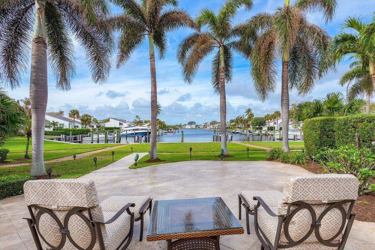 Boater's Paradise ! If you've dreamed of waterfront living in an exclusive gated boating community just steps from the beach, look no further than this stunning property in Pelican Cove.