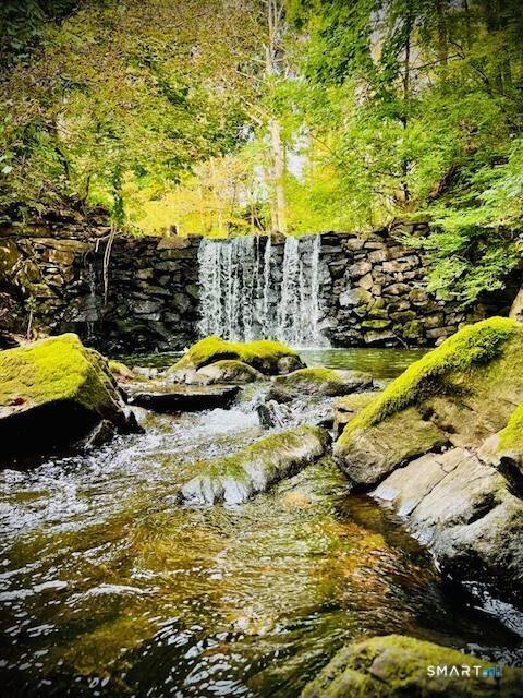 Renovated c. 1860 cottage set along the East Aspetuck River in the heart of historic New Preston.