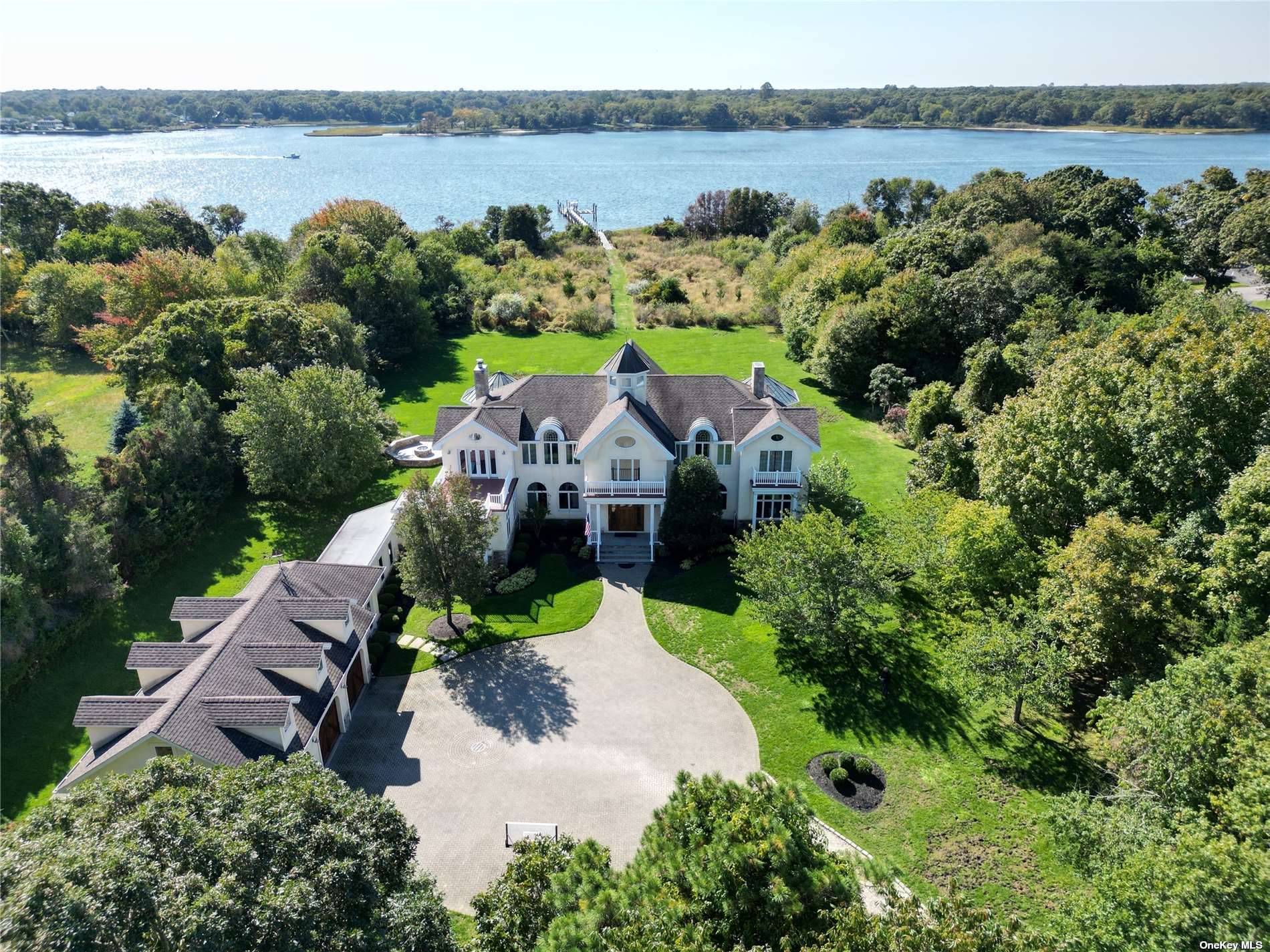 Escape to a serene 4. 74 acre waterfront haven in Center Moriches.