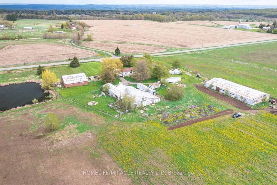 49. 22 Acres corner farm house with Charming 3 Bedroom, 2 Car Garage Bungalow, Multi use other Buildings including Two Barns, Storage space, Drive in Shop.