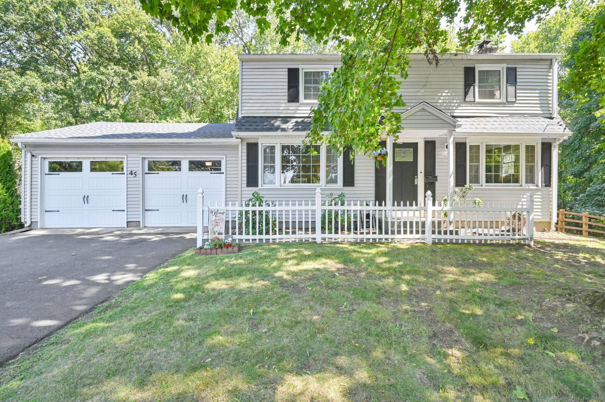 Spacious 4 bedroom home on a desirable corner lot with wooded backyard views !