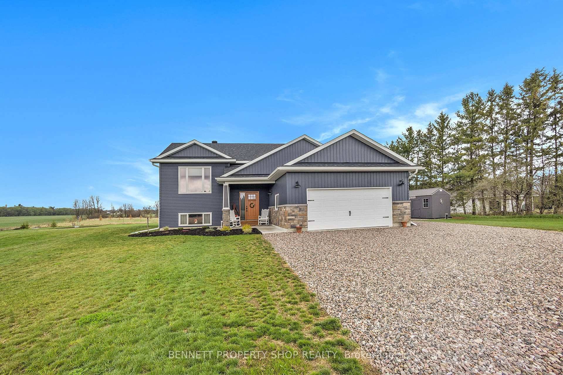 Welcome to this stunning, newer raised bungalow that perfectly blends modern living with the tranquility of rural surroundings, just minutes from a boat launch.