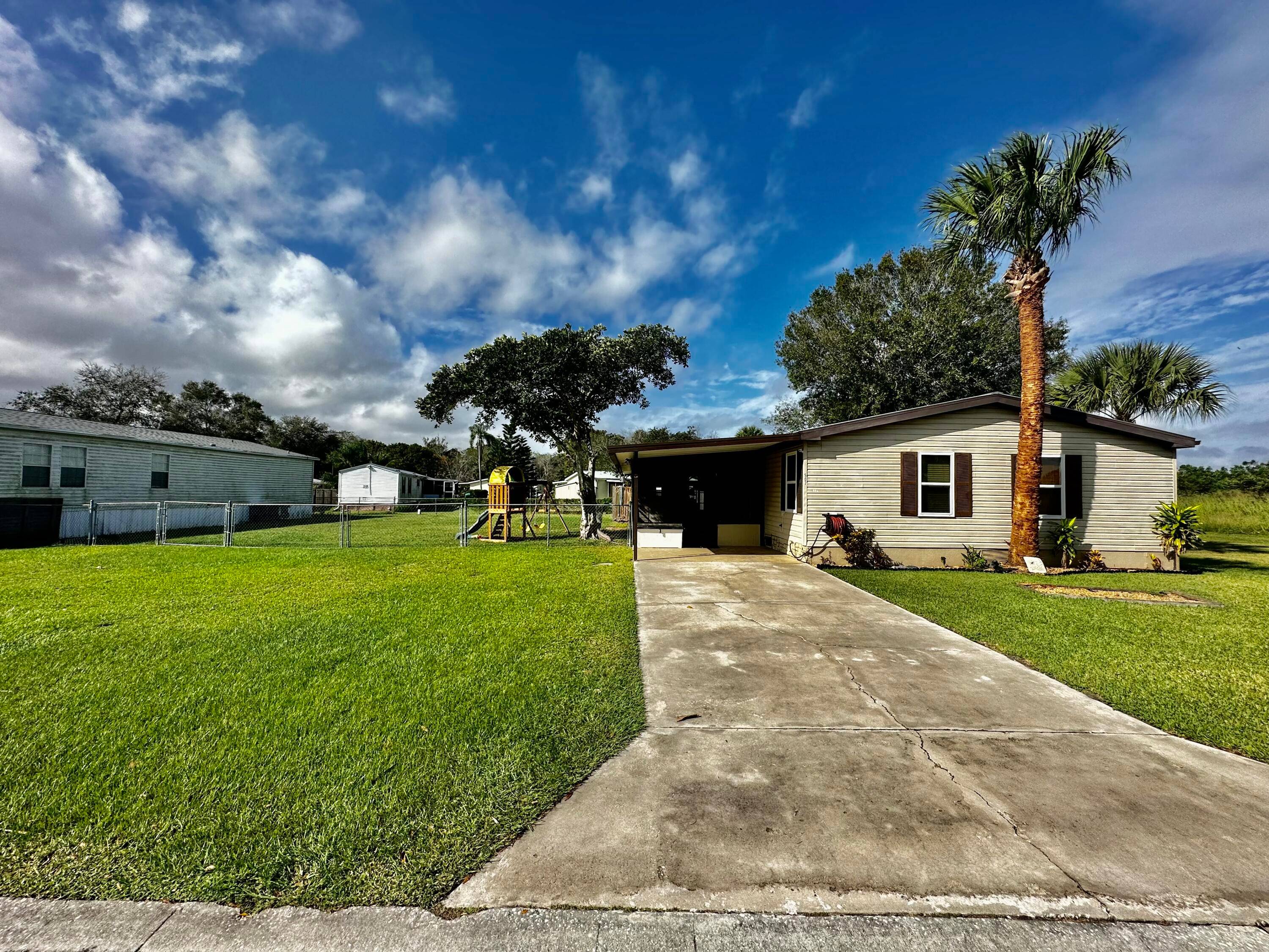 NO HOA Charming 4 bedroom, 2 bathroom mobile home on a spacious quarter acre lot spanning two lots for added privacy.