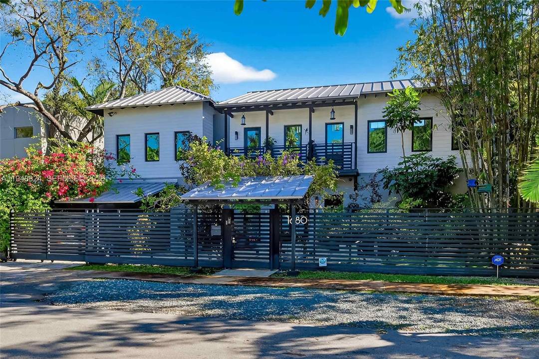 Exquisite North Coconut Grove sanctuary situated on one of the area s quietest, tree lined streets.