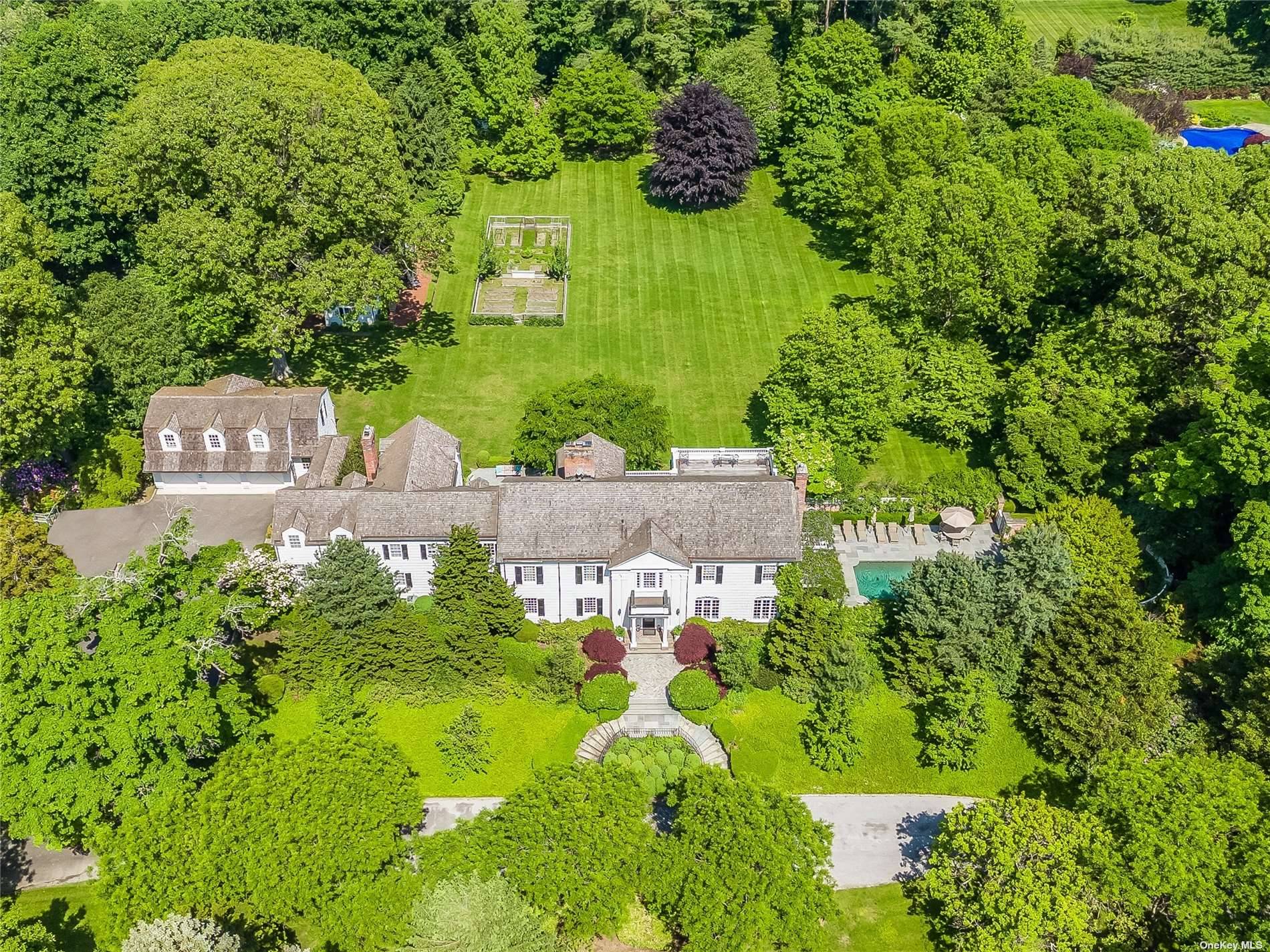 Experience the pinnacle of opulence with this extraordinary 1925 Colonial estate nestled within the esteemed Village of Matinecock.
