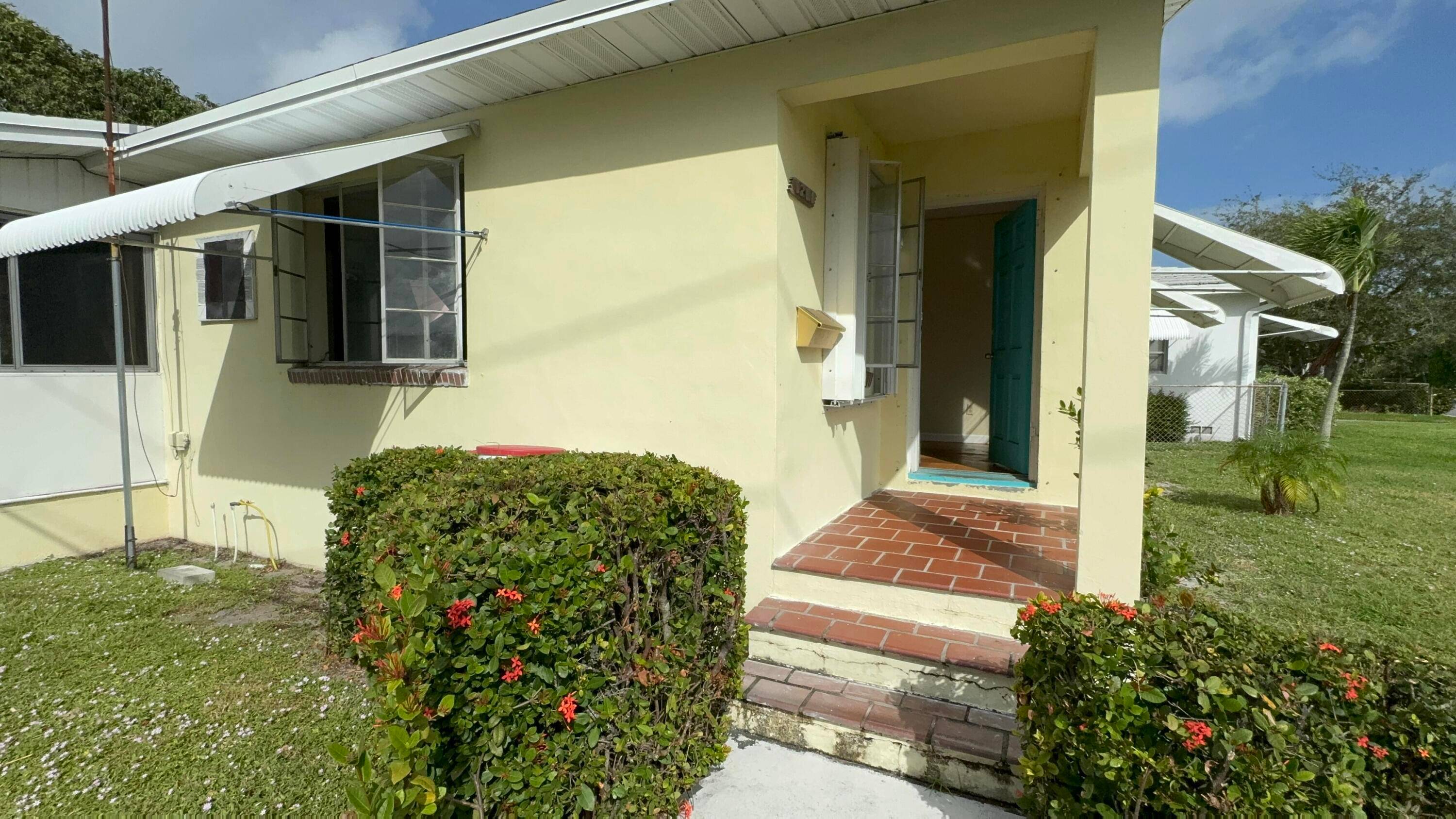 Charming 2 bedroom, 1 bathroom home nestled in the heart of Lake Worth Beach sit on a corner lot.