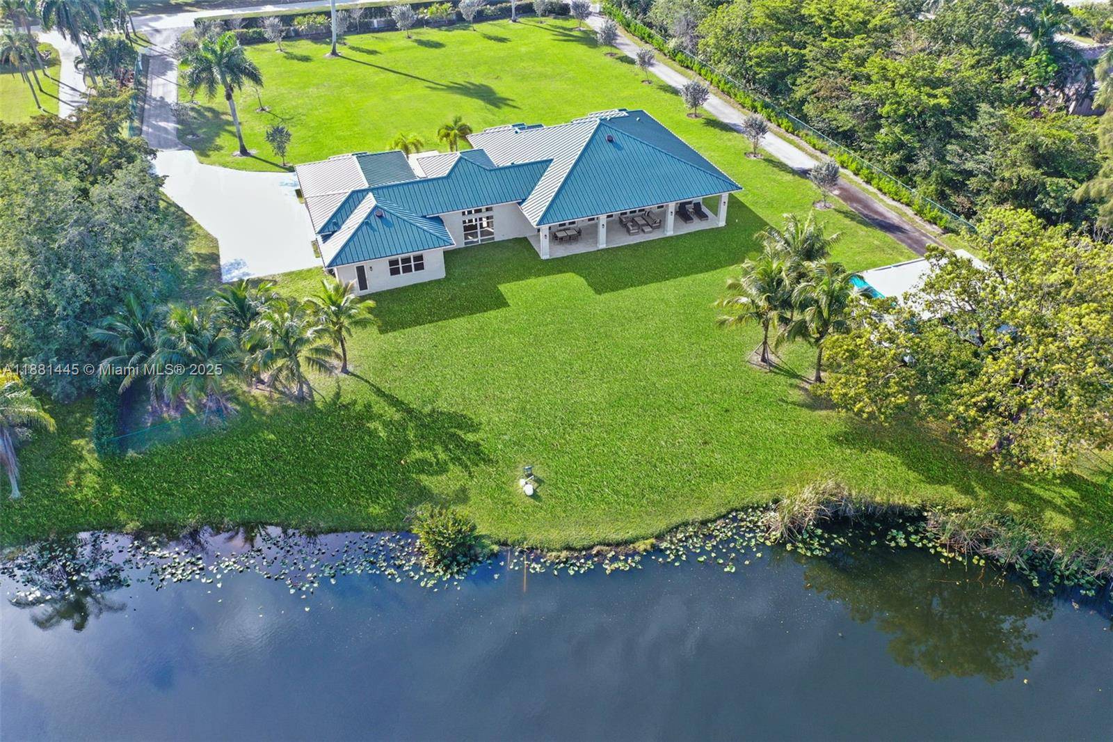 Exquisite 2021 custom built modern compound on 2 gated acres w private lake.