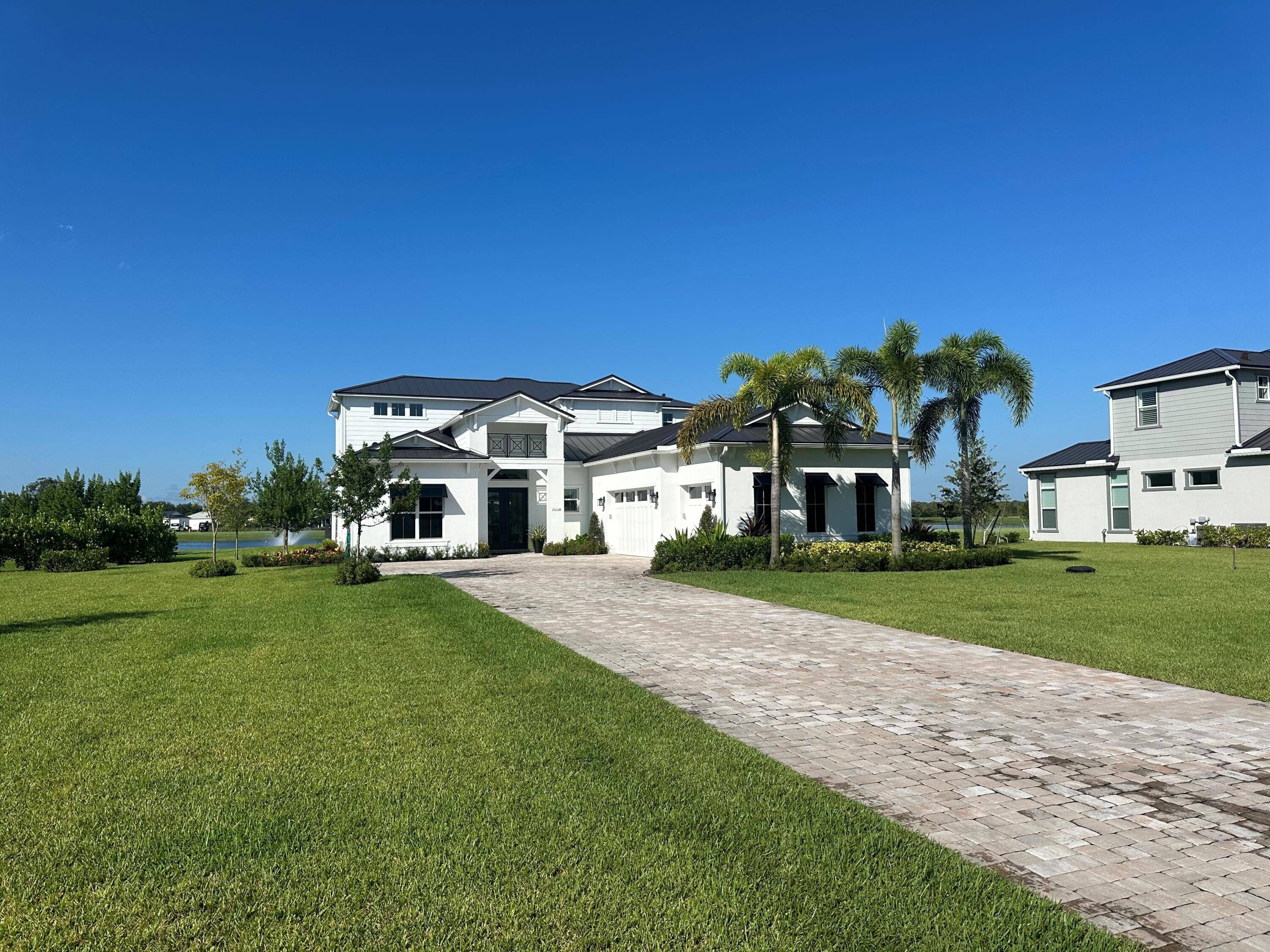 Enjoy wide water views across a large lake with fountain in Bridgewater, one of the hottest selling communities in Jupiter, Florida.