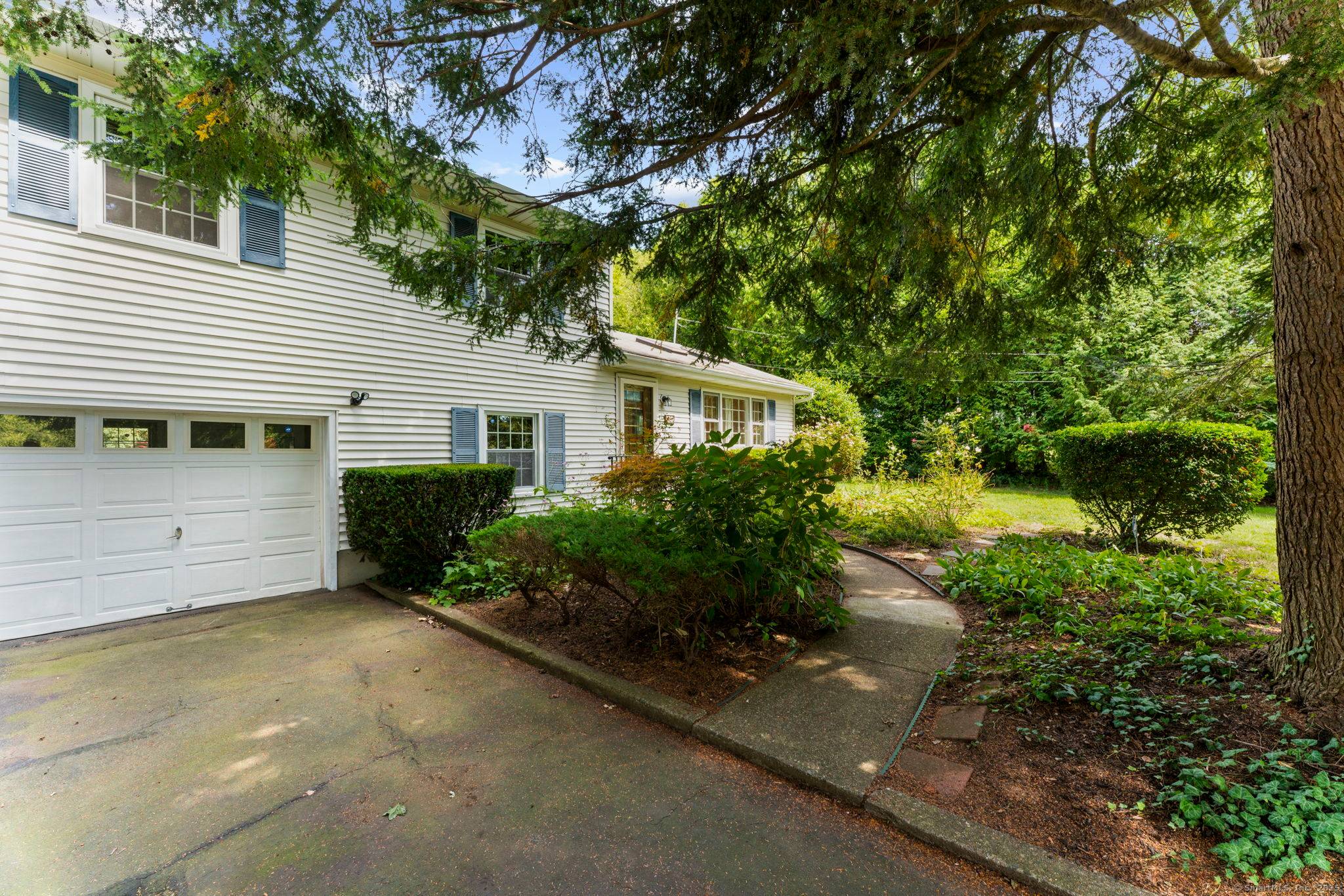 Welcome to this Quaker Hill classic split level home offering three bedrooms and three full bathrooms, set on a lovely lot with a beautiful yard.