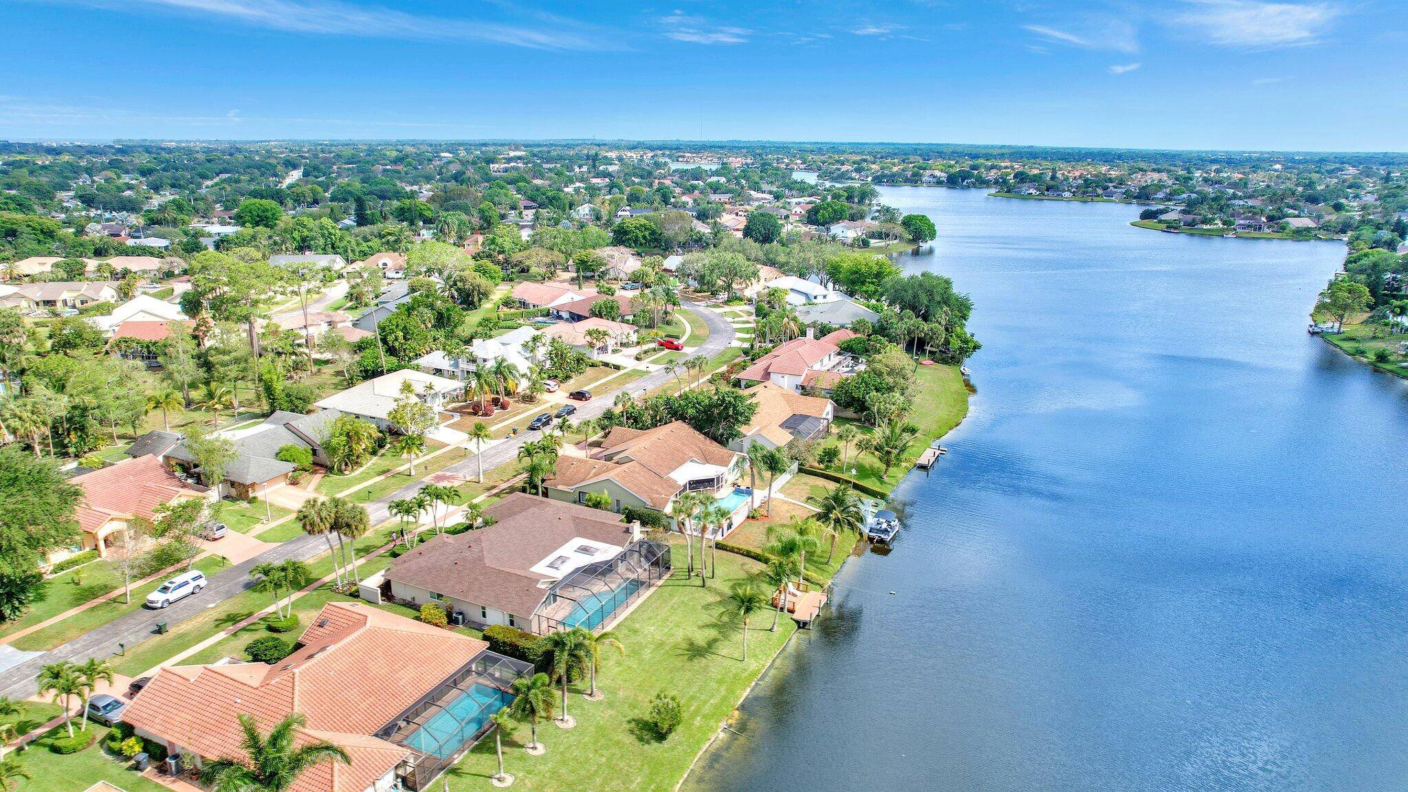 EXPERIENCE THE EPITOME OF LAKESIDE LUXURY IN THIS CAPTIVATING HOME !