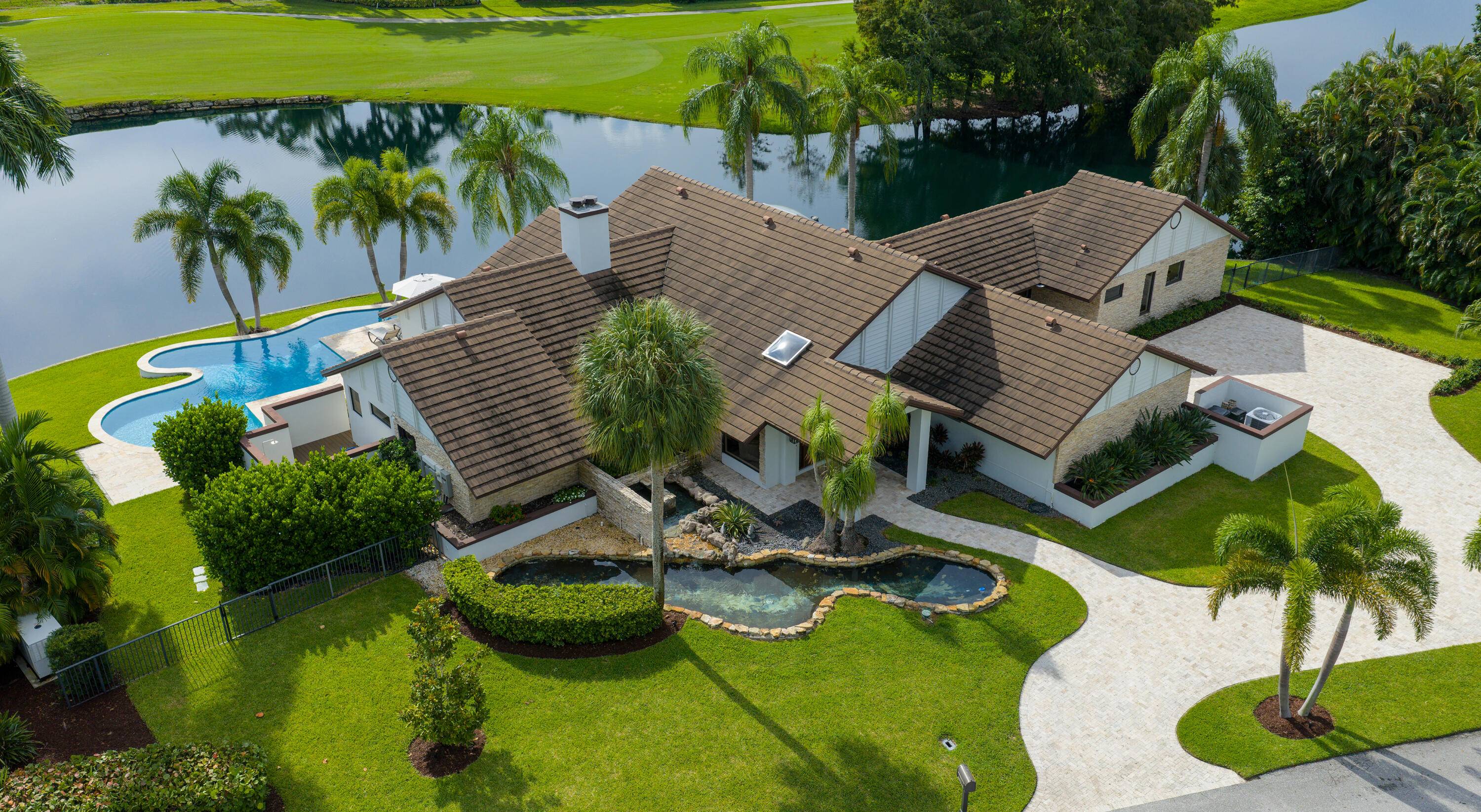 Enveloped within the beauty of its natural setting and defined by luxury, this completely remodeled East Coast style residence captures tranquil panoramic lake and fairway views as well as beautifully ...