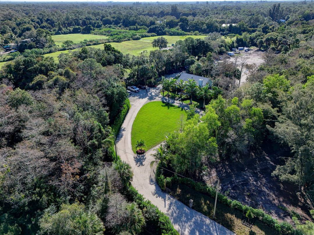 Private 5. 67 acre CBS home built in 2000, surrounded by preserved lands and minutes from Riverbend Park in highly desirable Jupiter Farms.