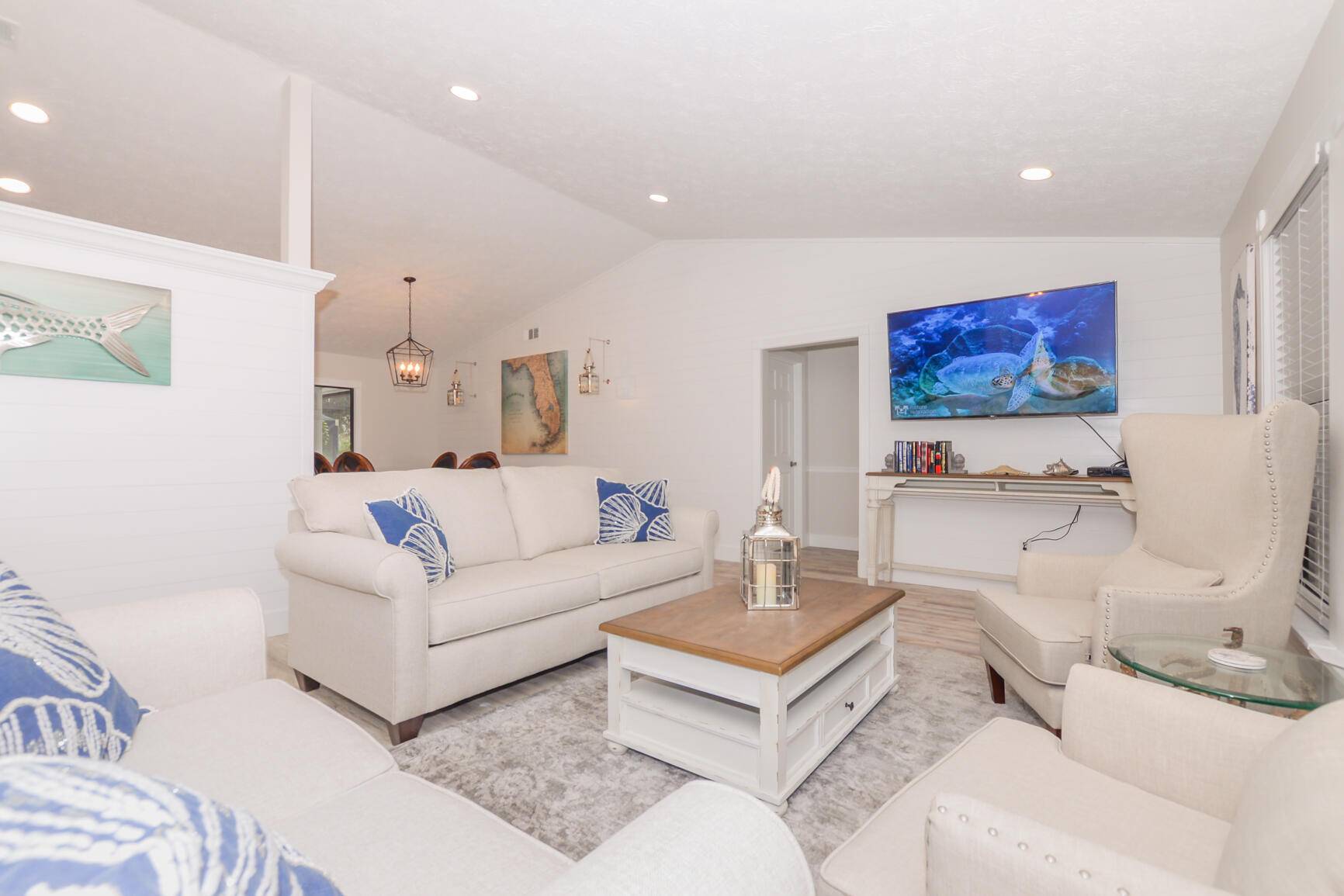 This Gorgeously remodeled Florida Coastal Home is hidden in the charming community of Pinecrest Lakes with private natural trails, private tennis courts, a private community playground.