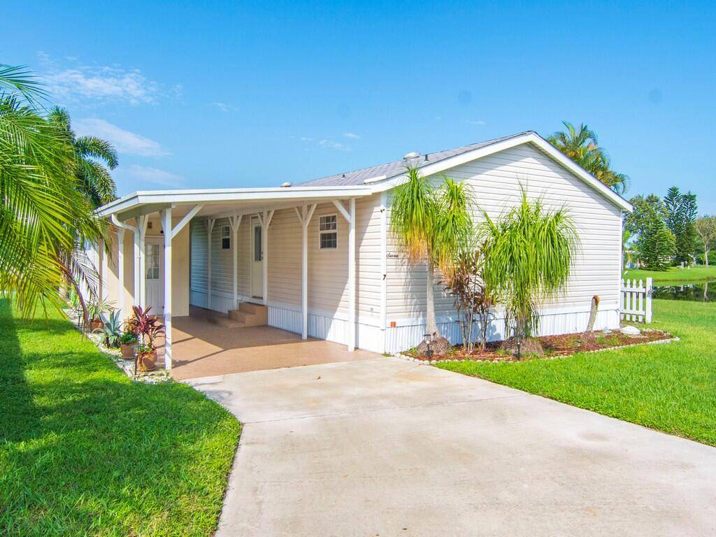 Charming waterfront retreat in Spanish Lakes Riverfront, a 55 community nestled on a quiet cul de sac.