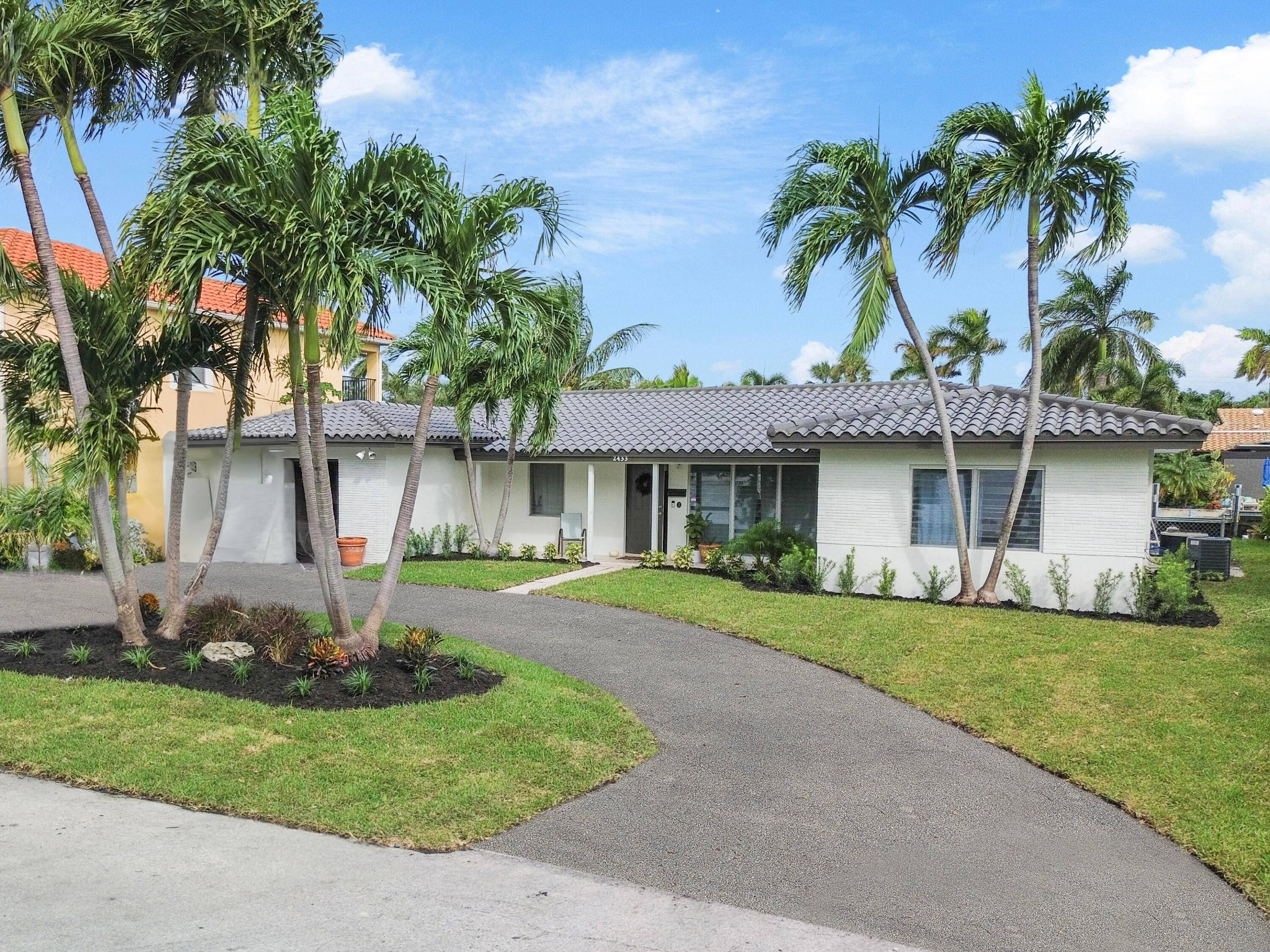 Live in the heart of Pompano Beach in this stunning, remodeled waterfront home on a quiet cul de sac in Pompano Isle.