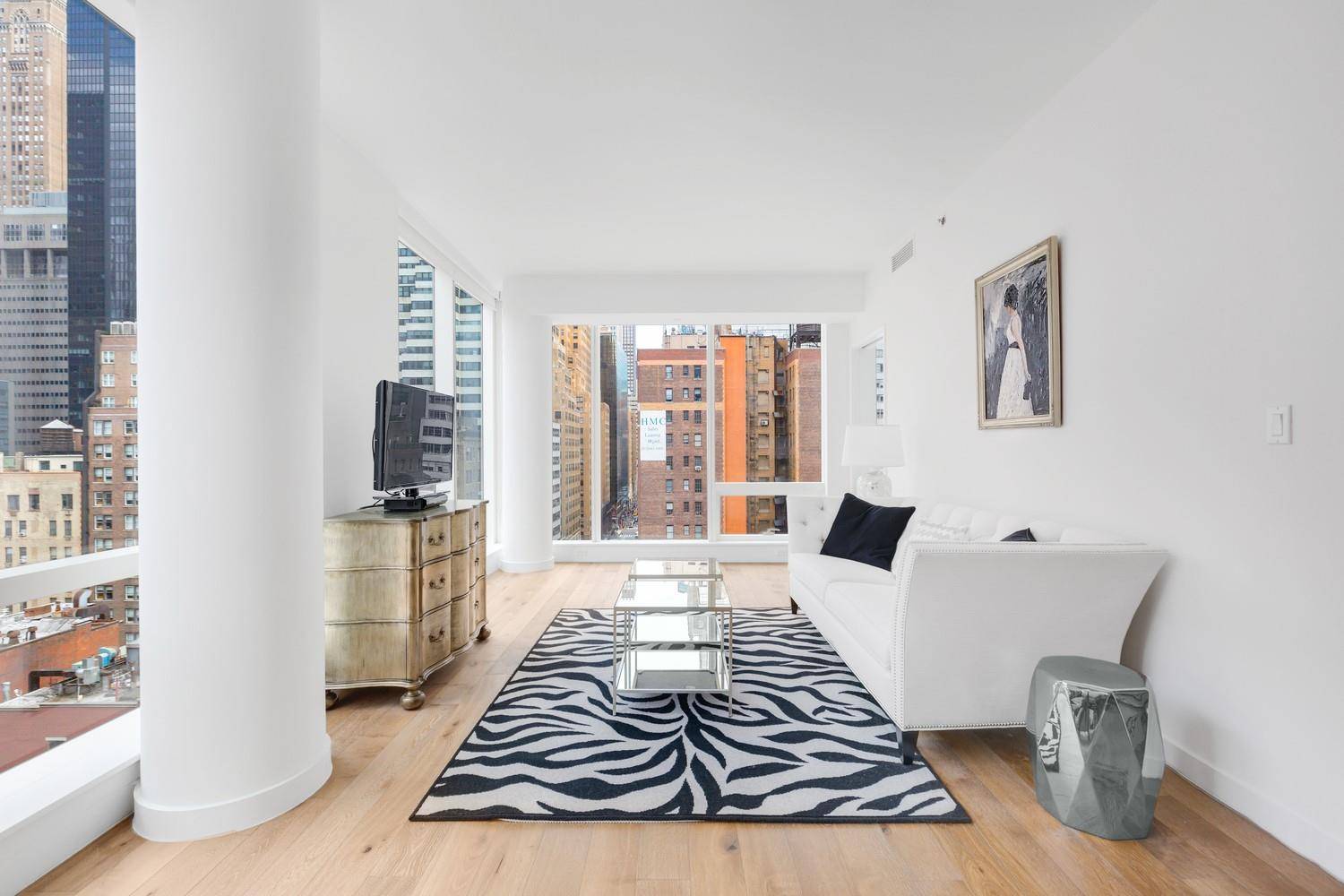 Bright and beautiful corner living room with a North and West exposures, featuring a modern Open Chef s Kitchen, white quartz counters and top of the line appliances from Liebherr, ...