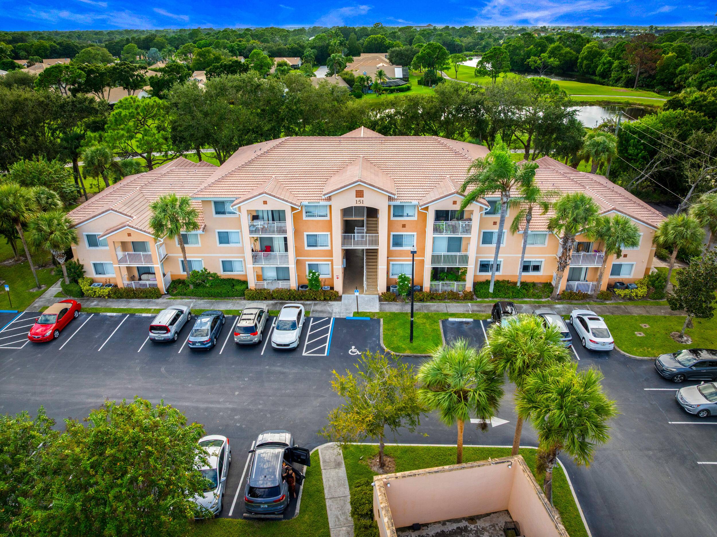 Enjoy sweeping golf course and pond views from this bright corner unit in the gated community of The Club at St.