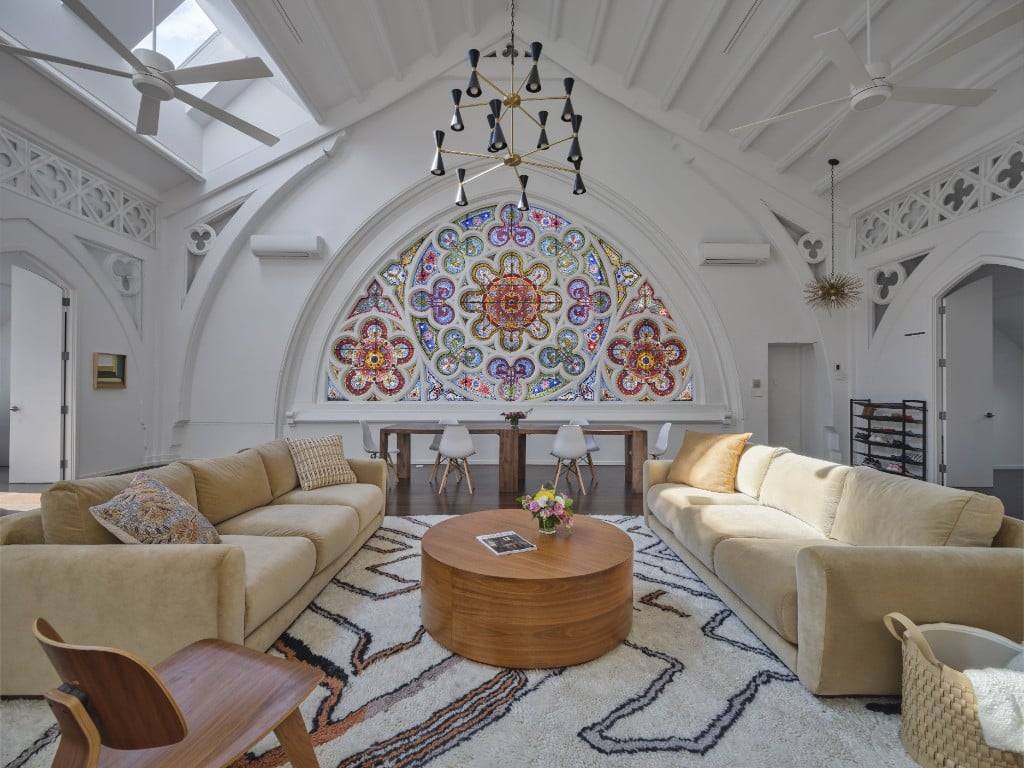 Soaring 23' beamed cathedral ceilings with a huge historic stained glass window creates an expansive feel in this historic church loft apartment, featuring an almost 1, 000 sq ft living ...