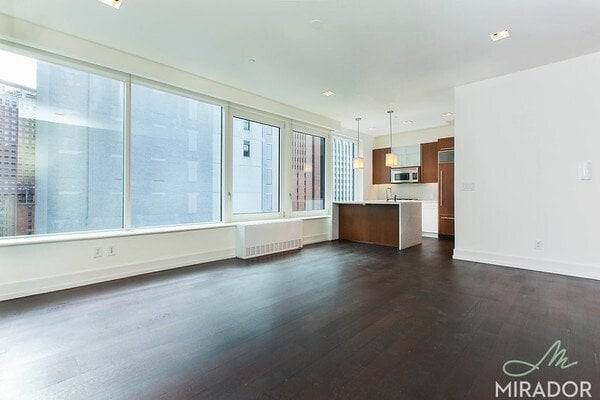 Large corner one bedroom unit with large open island kitchen, living room area, queen sized bedroom with walk in closet and washer dryer in the unit.