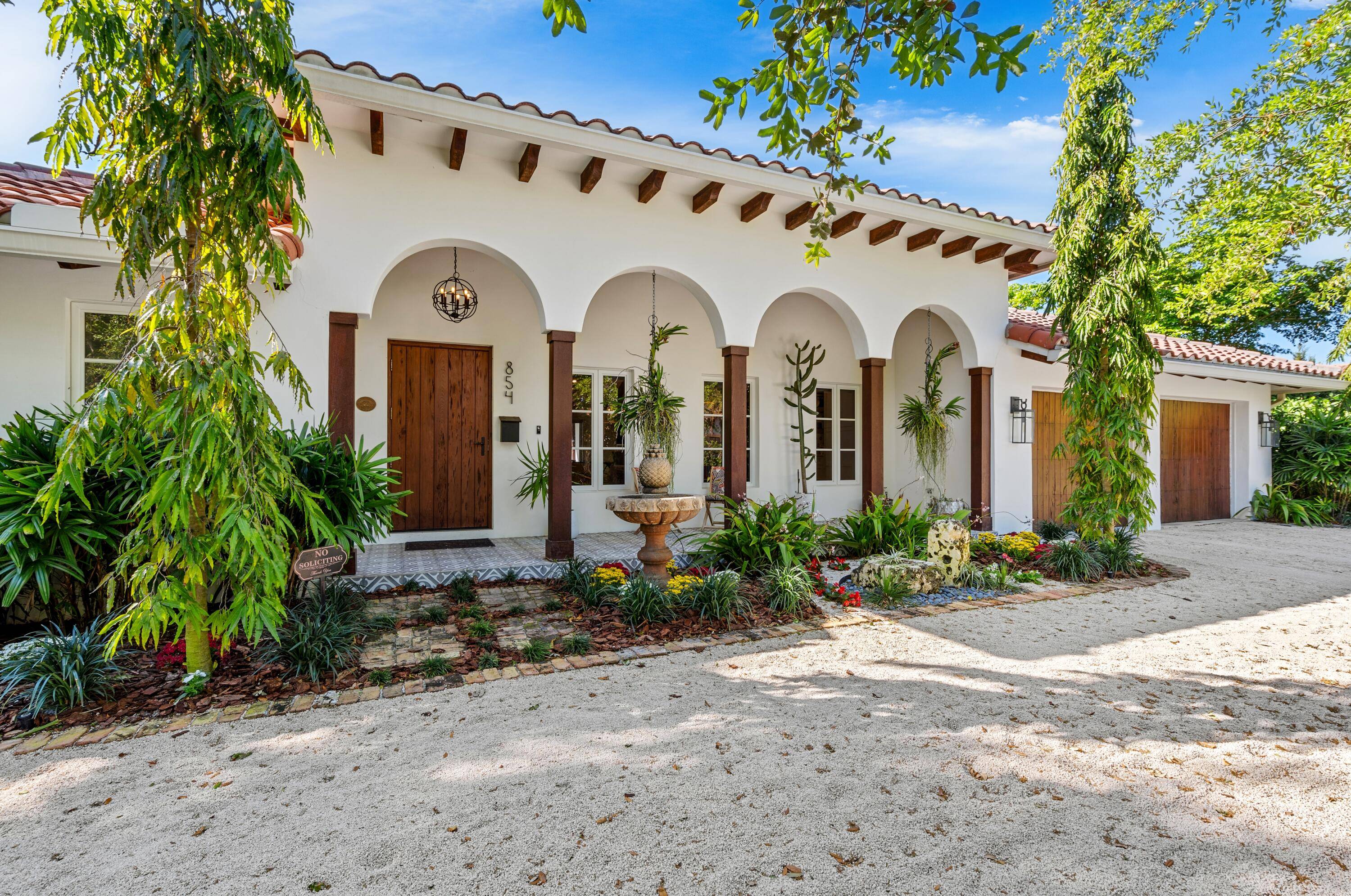 In keeping with Mizner's original Spanish Colonial architectural vision, the front facade is characterized by a triple colonnade of arches, accented with outriggers and wood columns ; a front lanai ...