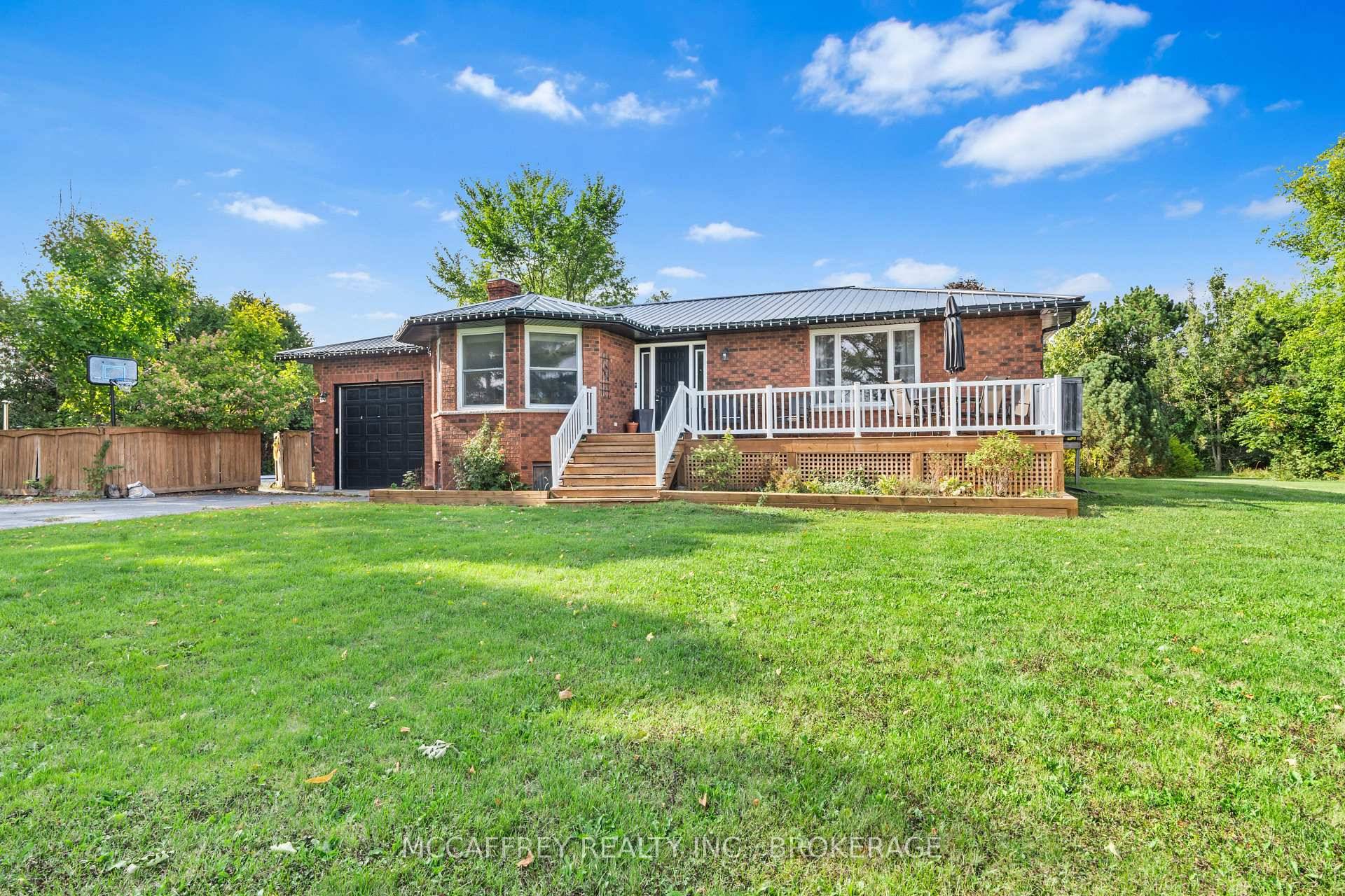 Welcome to this lovely all brick bungalow, boasting an impressive renovation and offering an attached one car garage, situated on more than an acre of beautiful country landscape.