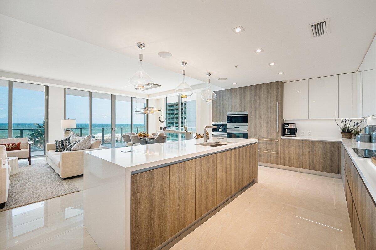Enjoy oceanfront sunrises and sunsets over the intracoastal from this 2 bedroom den floor through residence designed by Bob Martin of Decorators Unlimited.