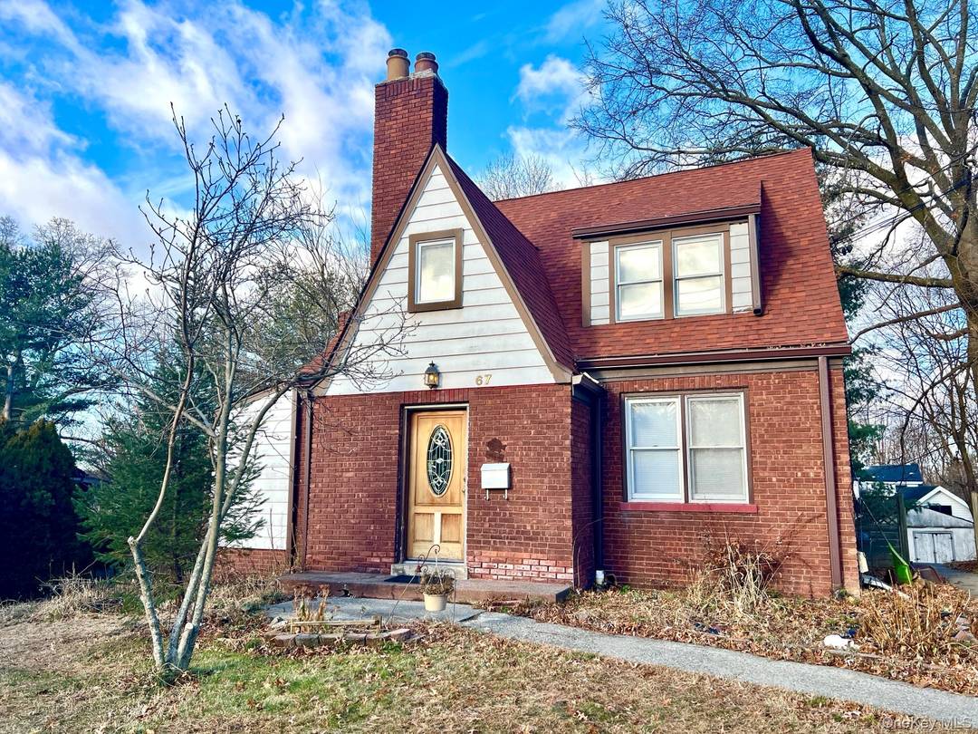 Unusual find Charming Tudor style brick 2 family in residential neighborhood.