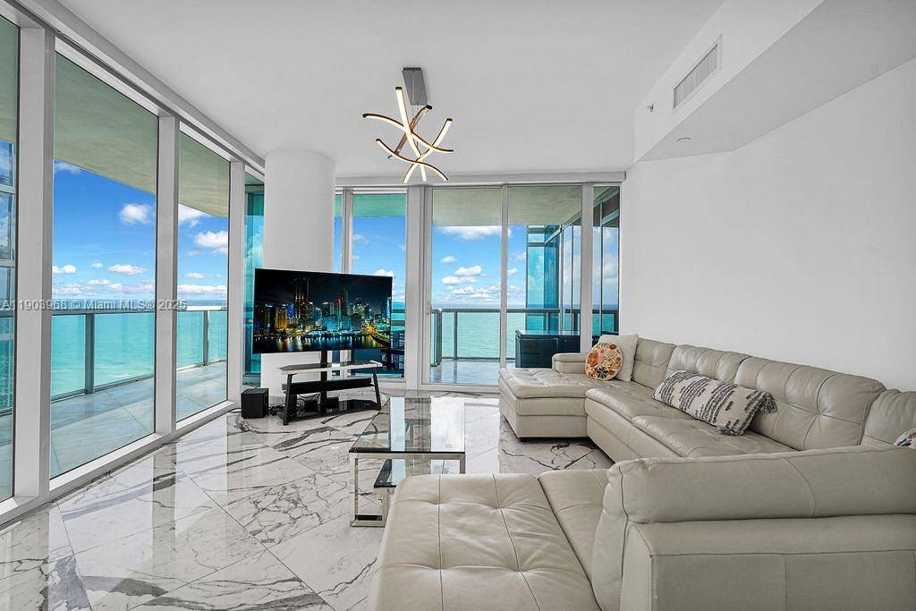 Experience luxury beachfront living in this 3 bed, 3.