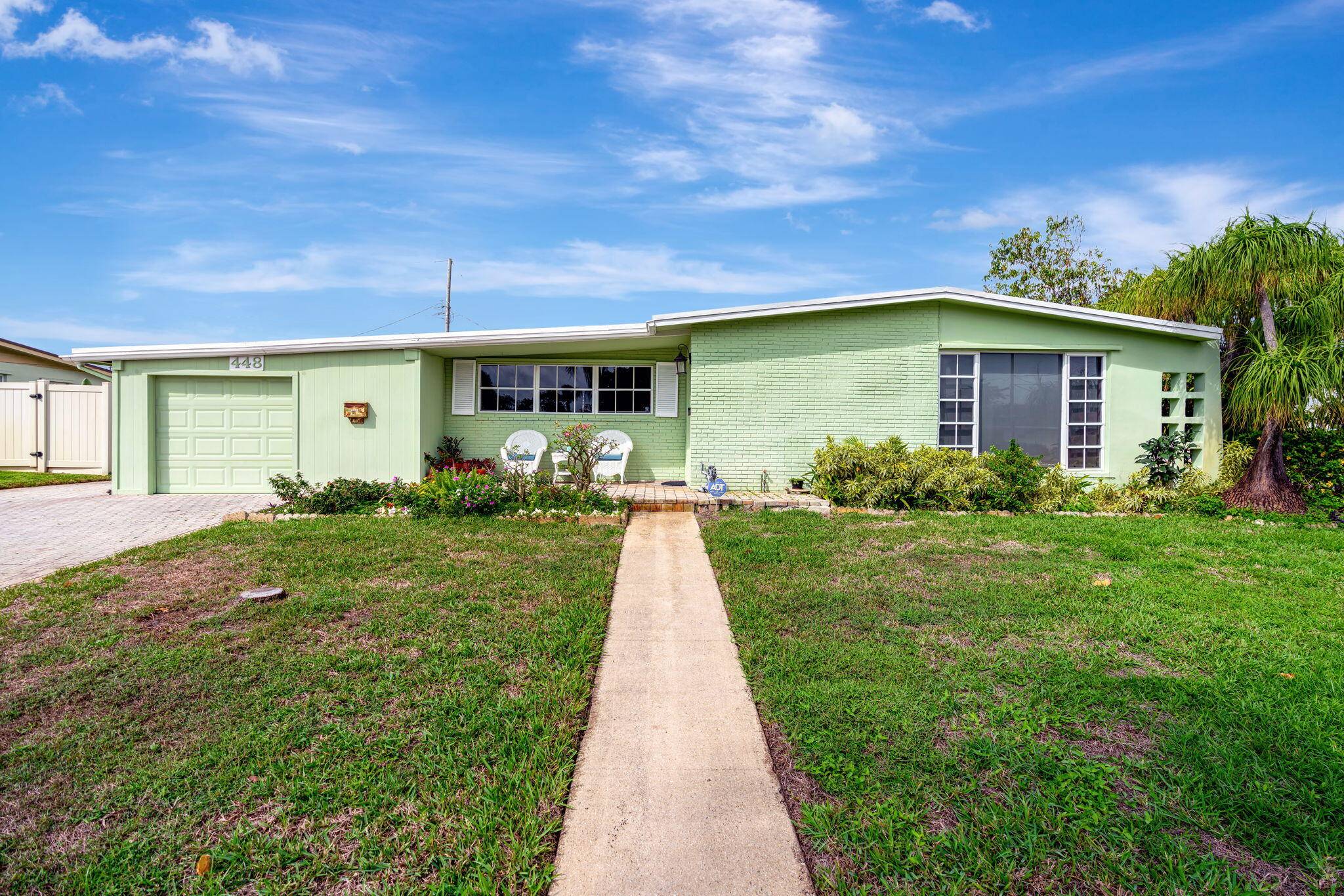 Welcome to this charming CBS mid century home nestled on a desirable corner lot in North Palm Beach.